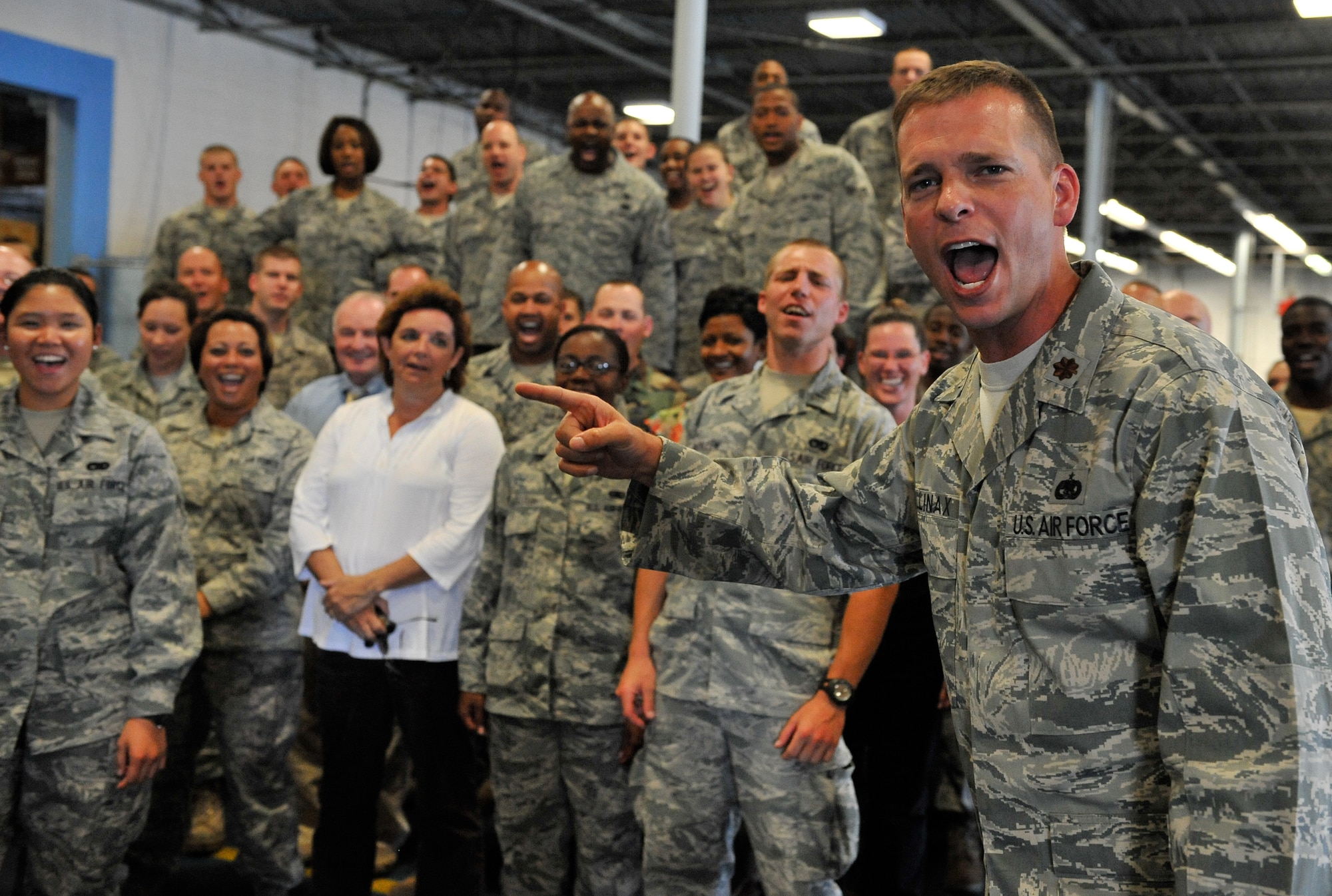 SHAW AIR FORCE BASE, S.C. -- Major Anthony Mullinax, 20th Logistics Readiness Squadron's new commander, does a warrior cry with his troops, Sept. 8. "My primary goal is building a single LRS culture amongst multiple stove-pipe Air Force service codes," he declared. "The new squadron motto is 'sustineo vel intero,' meaning 'sustain or die.'"(U.S. Air Force photo/Senior Airman Kathrine McDowell)