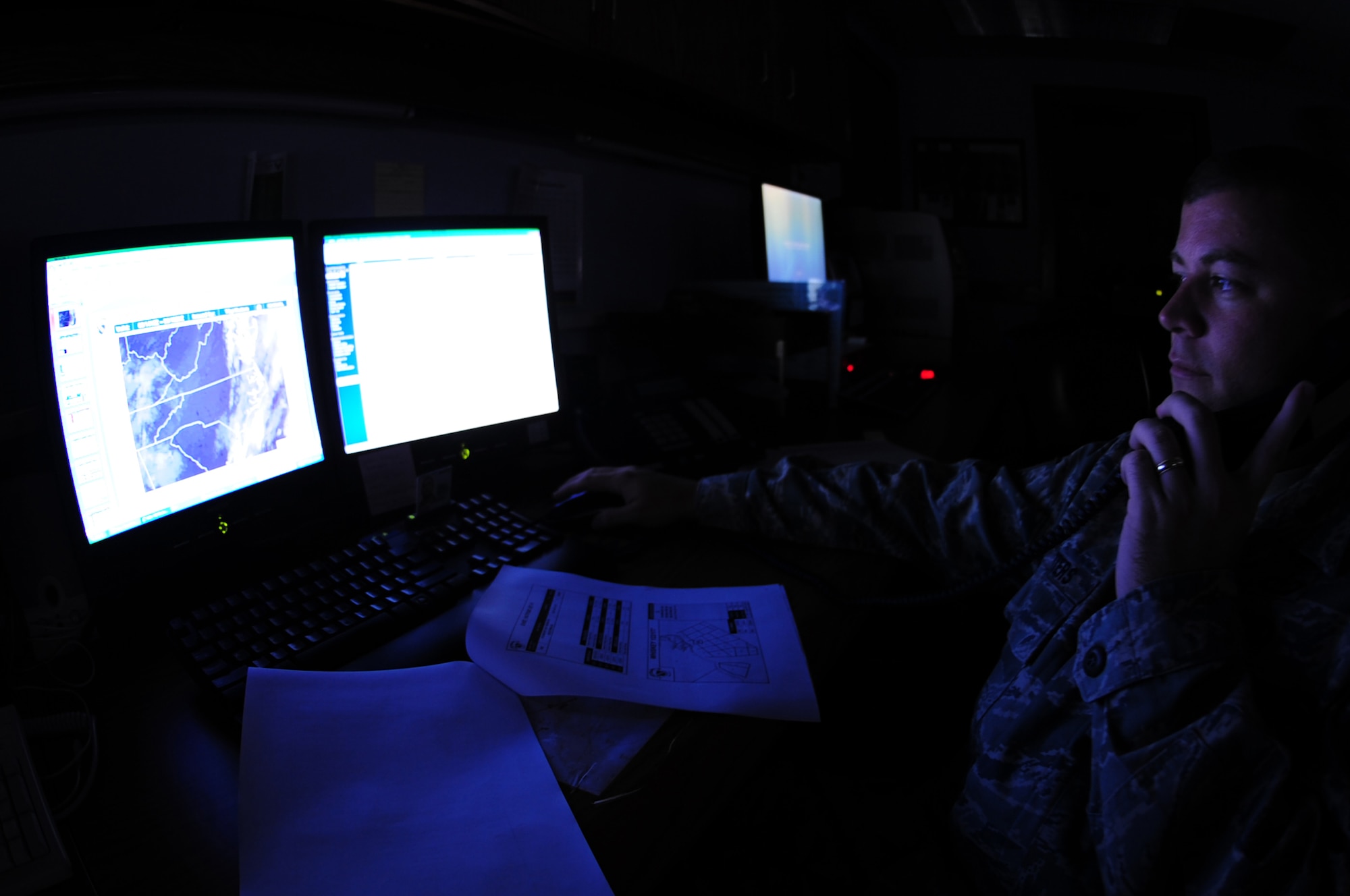 Tech. Sgt. Robert Mutters, 4th Operations Support Squadron weather technician, gives a weather planning brief to a pilot over the phone at Seymour Johnson Air Force Base, N.C., Sept 3, 2009. The weather office provides pilots and weapon systems officers with up-to-the-minute flying conditions before take-off. (U.S. Air Force photo by Airman 1st Class Rae Perry)
