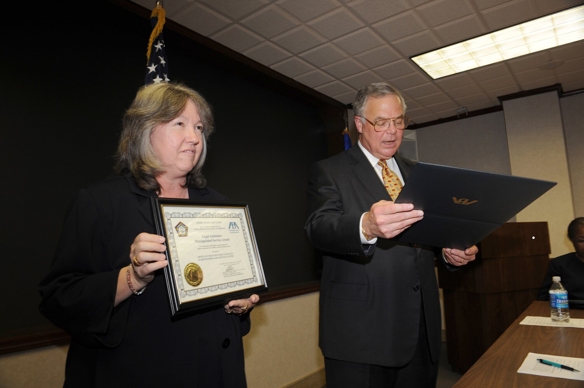 John Odom Jr., ABA representative, presents the Legal Assistance to Military Personnel Distinguished Service Award to the WR-ALC Judge Advocate office. U. S. Air Force photo by Tommie Horton