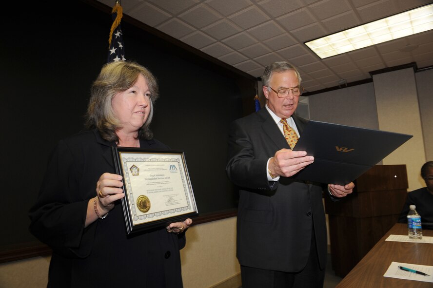 John Odom Jr., ABA representative, presents the Legal Assistance to Military Personnel Distinguished Service Award to the WR-ALC Judge Advocate office. U. S. Air Force photo by Tommie Horton
