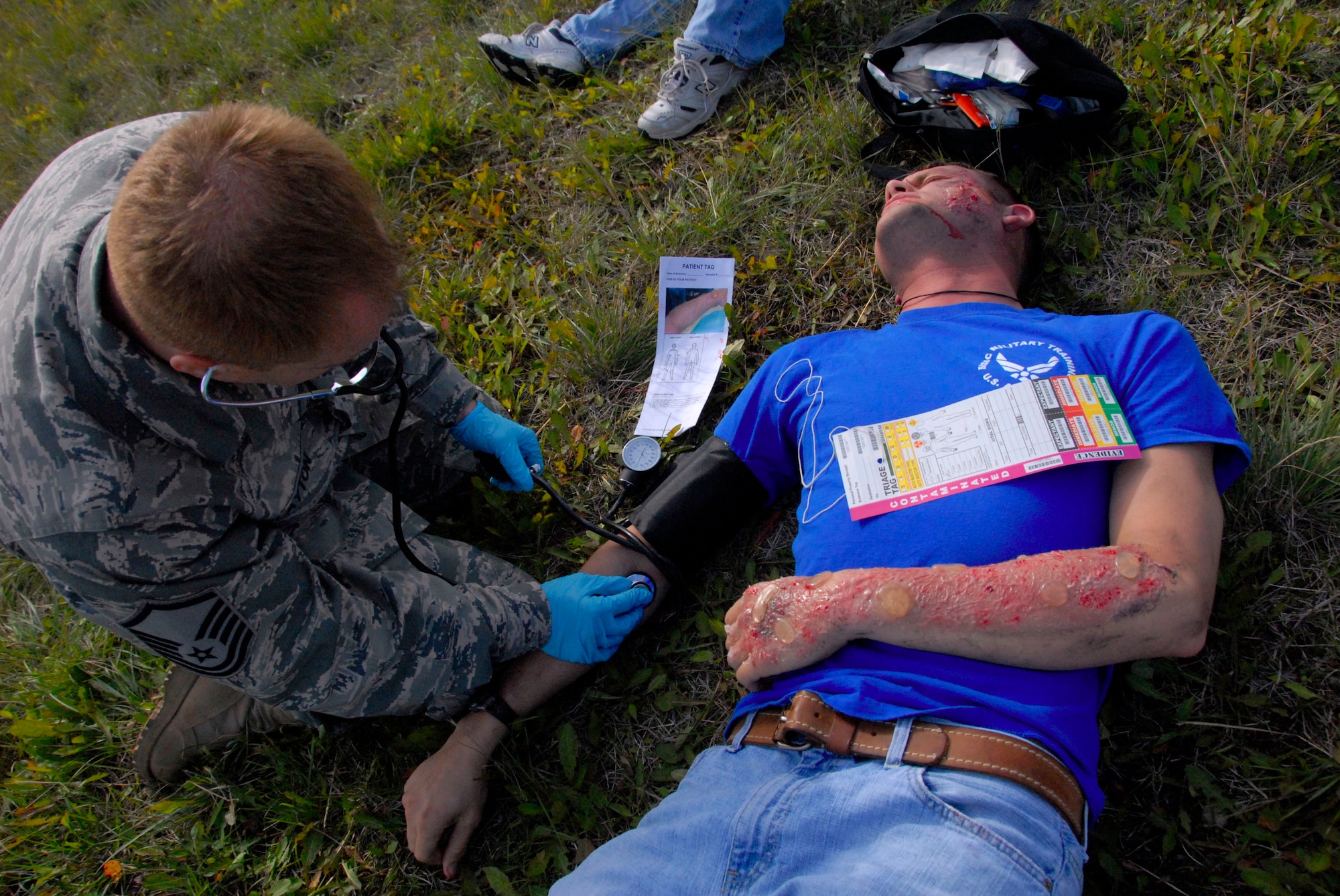 ELMENDORF AIR FORCE BASE, Alaska -- Medical staff check vitals on scene during an all hazards training exercise Sept. 9. "Victims" were asked to act as real as possible to ensure the best training scenario for the medical staff. Harris is an F-15 crew chief with the 3rd Aircraft Maintenance Squadron. (U.S. Air Force photo/Senior Airman Cynthia Spalding)