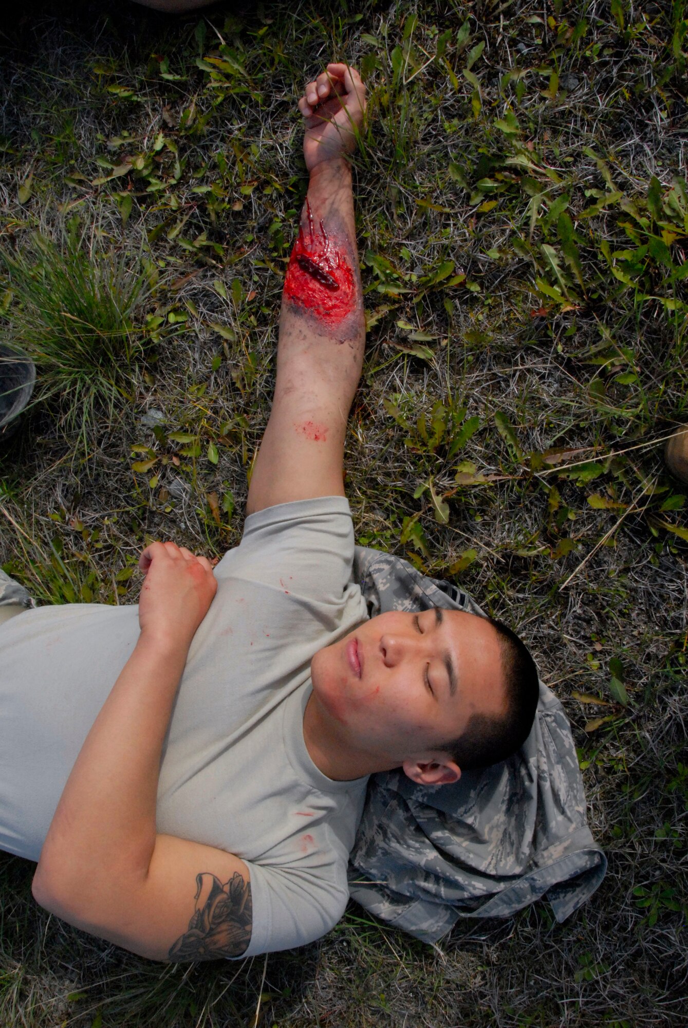 ELMENDORF AIR FORCE BASE, Alaska -- Airman 1st Class Nojin Park waits for medical support to arrive on scene during an all hazards training exercise Sept. 9. "Victims" were asked to act as real as possible to ensure the best training scenario for the medical staff. Park is a member of the 3rd Maintenance Operations Squadron. (U.S. Air Force photo/Senior Airman Cynthia Spalding)