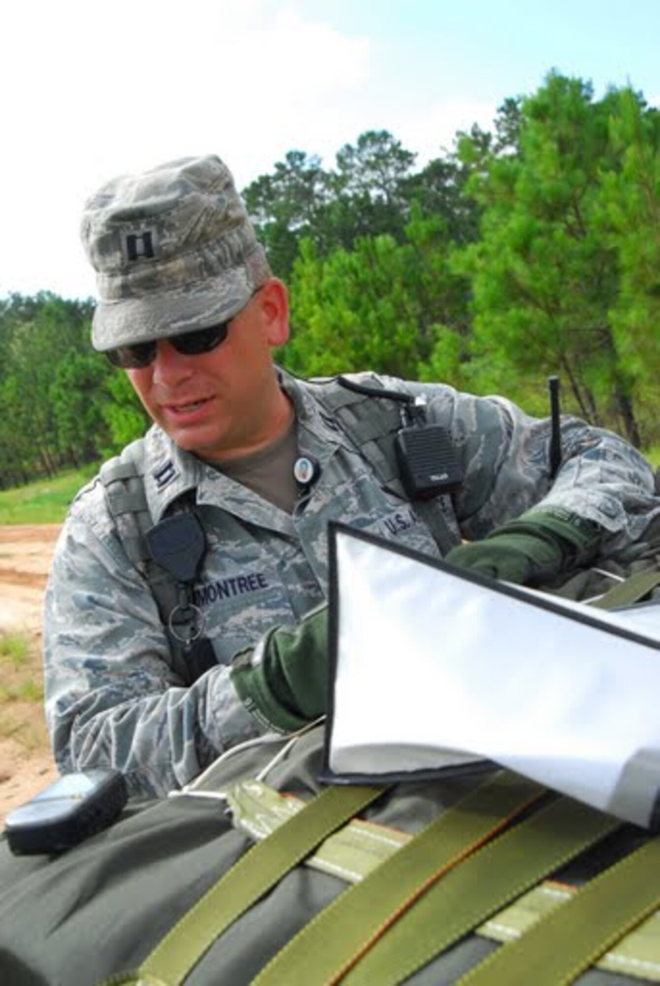 Prior to a supply drop, Capt. Robert Hammontree, 34th Combat Training Squadron air mobility liaison officer assigned to Ft. Polk, La., advises soldiers on safe distances for ground forces around the drop zone Aug. 21. Soldiers from the 10th Mountain Division exercised their ability to secure and retrieve supplies from a drop zone. (U.S. Air Force photo by Staff Sgt. Juan Torres)