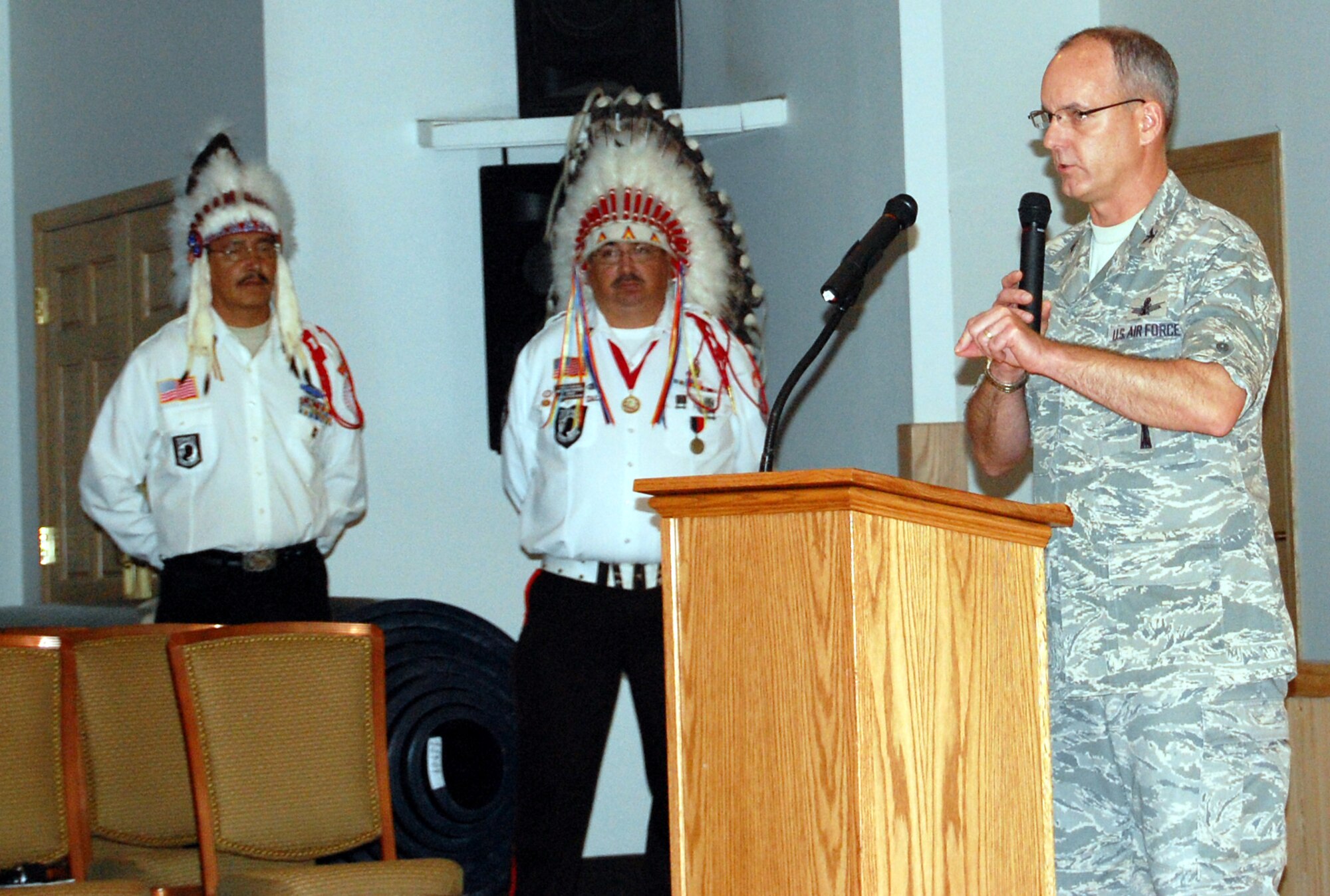 Col. Michael Fortney, 341st Missile Wing commander, delivered the opening remarks for Malmstrom's first-ever Multi-Cultural Celebration Sept. 3. Members of the Blackfeet Warrior Society, who has just posted the colors, look on. (U.S. Air Force photo/Valerie Mullett)