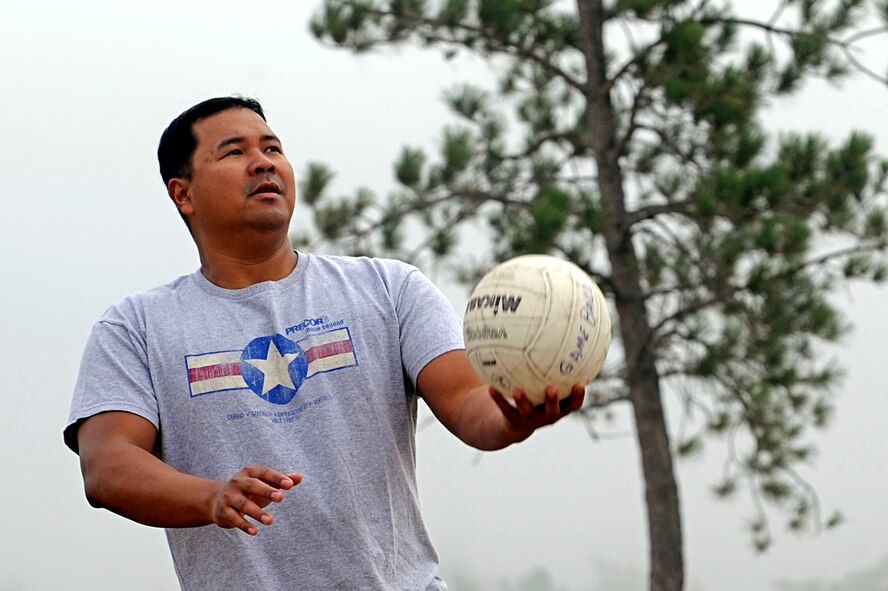 Tech. Sgt. Audy Doctora, 28th Force Support Squadron NCO in charge of the flight kitchen, begins his serve during a game of blind volleyball here, Sept. 3. The base picnic had multiple sporting events including volleyball, tug of war, dizzy bat racing and basketball. (U.S. Air Force photo/Airman 1st Class Matthew Flynn)