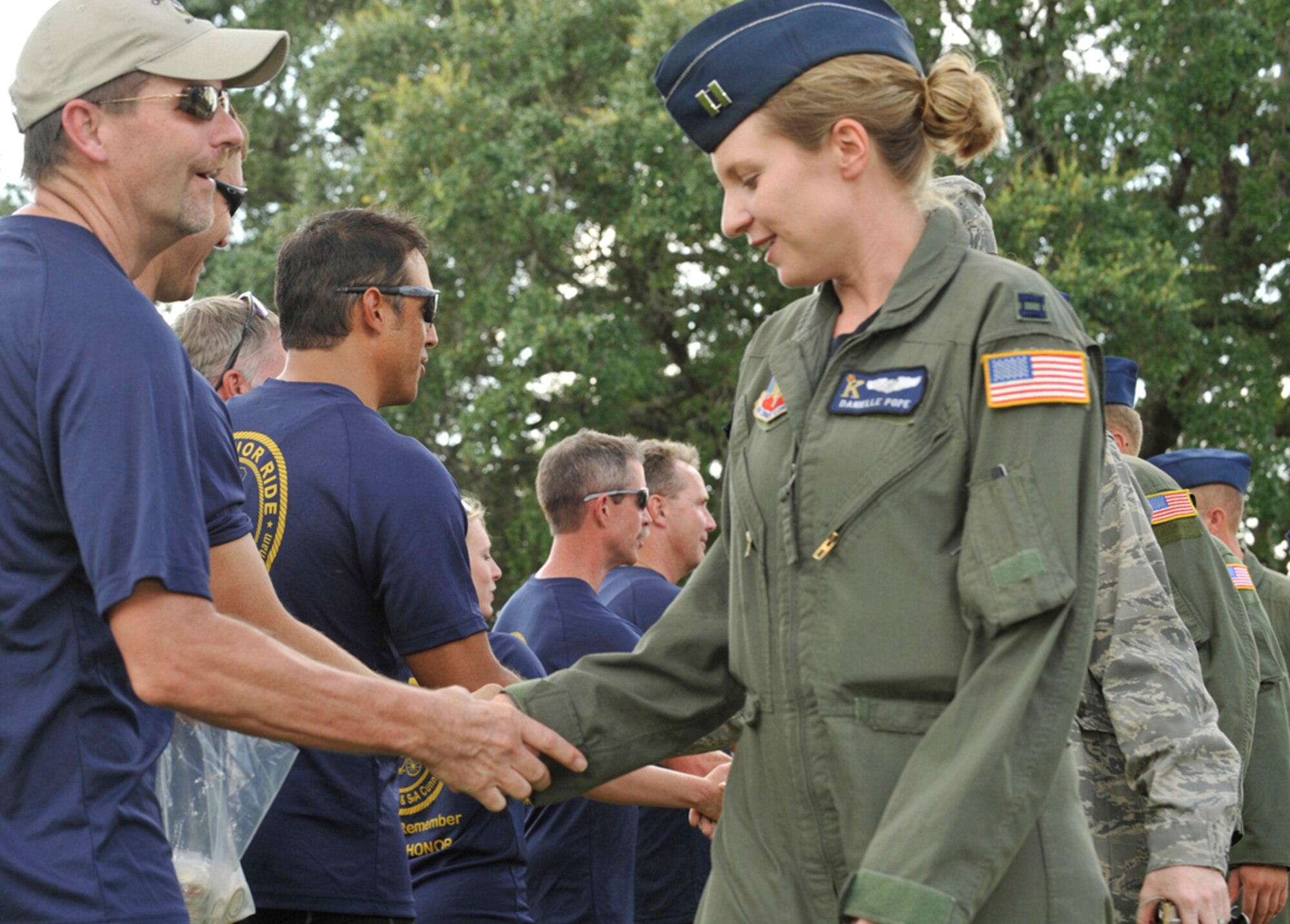 MOODY AIR FORCE BASE, Ga. -- Lt. Bill Stevens, City of Duluth Police Department police officer, presents Honor Ride challenge coins to all members of the 38th Rescue Squadron who were in attendance during the Operation One Voice Honor Ride memorial ceremony here Sept. 9.  (U.S. Air Force photo by Senior Airman Schelli Jones)