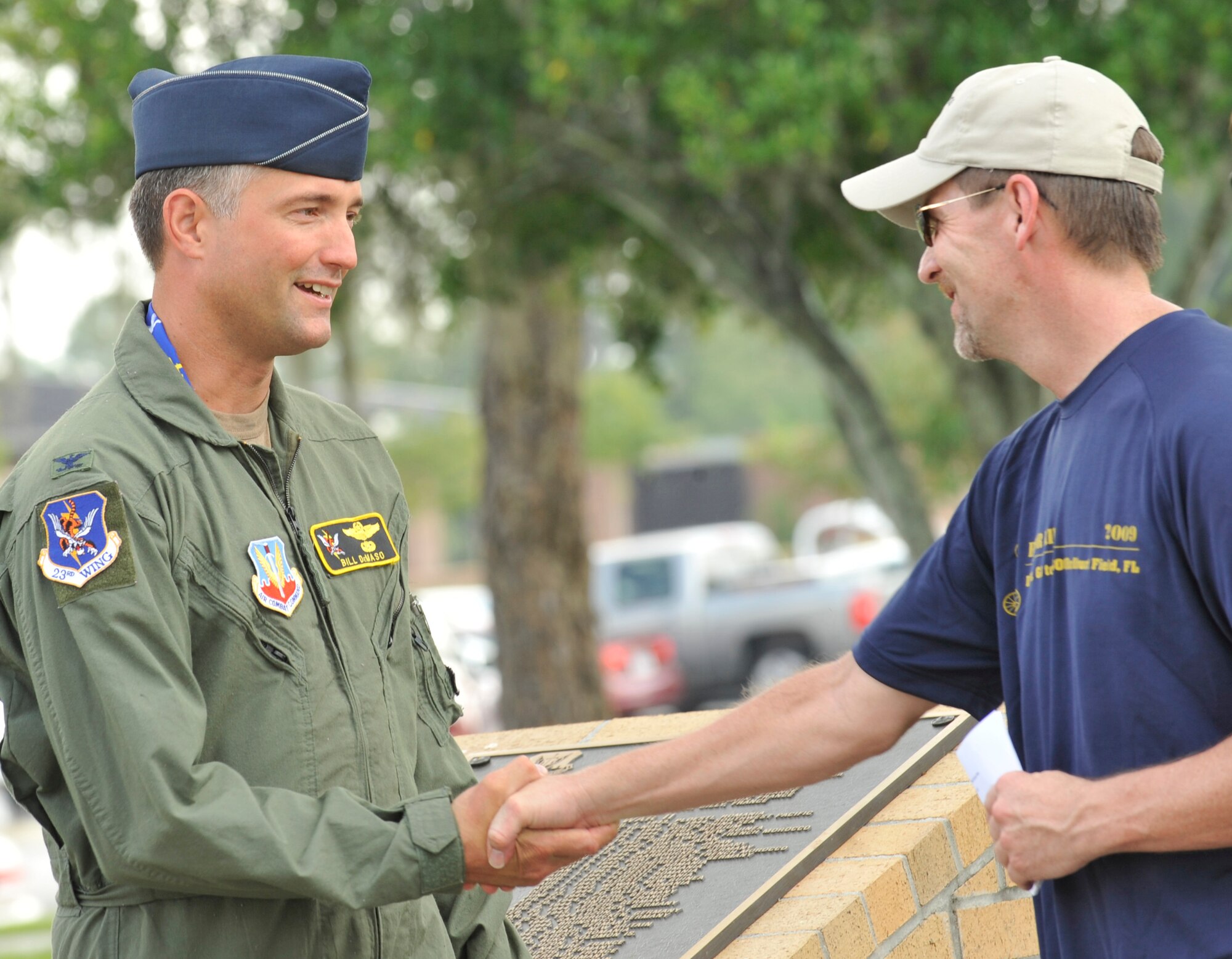 MOODY AIR FORCE BASE, Ga. -- Col. William DeMaso, 23rd Wing vice commander, is presented a coin from Lt. Bill Stevens, City of Duluth Police Department police officer, during the Operation One Voice Honor Ride memorial ceremony here Sept. 9. Lieutenant Stevens is one of 10 cyclists who is participating in a three-day, 500-mile bicycle ride to honor fallen special operations members. (U.S. Air Force photo by Senior Airman Schelli Jones)