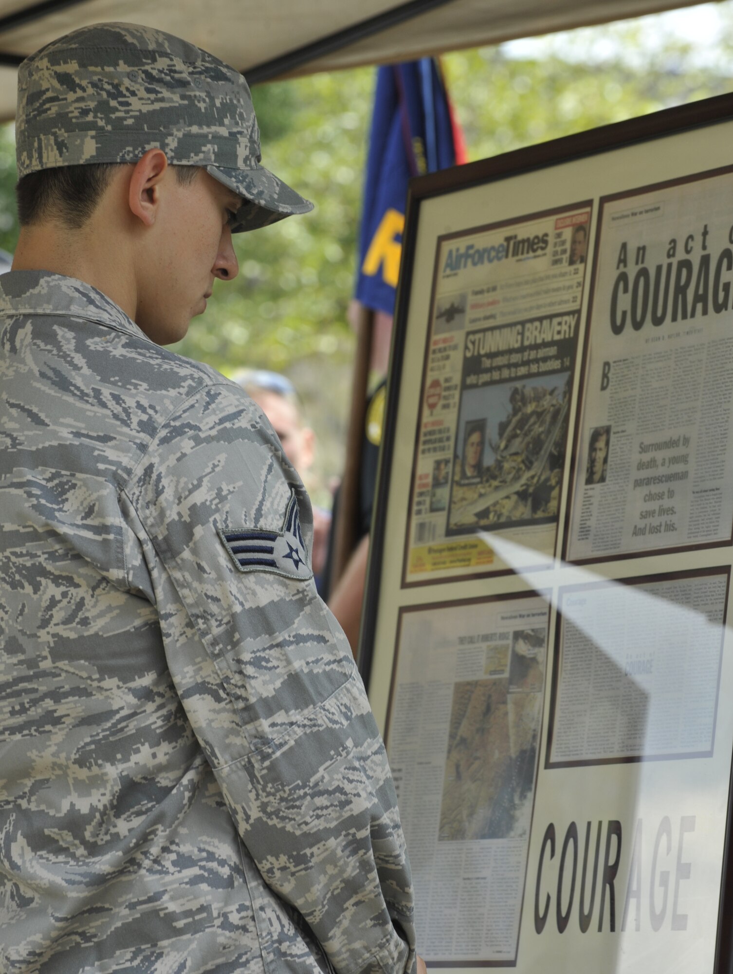 MOODY AIR FORCE BASE, Ga. -- Senior Airman Christopher Saavedra, 71st Rescue Squadron HC-130P/N Combat King loadmaster, reads articles written about fallen Airman during the Operation One Voice Honor Ride memorial ceremony here Sept. 9. “Sergeant Chapman and Airman Cunningham are two examples of those who have made the ultimate sacrifice,” said Lt. Bill Stevens, City of Duluth Police Department police officer, who is participating in a three-day, 500-mile bicycle ride in honor of the fallen special operations members. (U.S. Air Force photo by Senior Airman Schelli Jones)