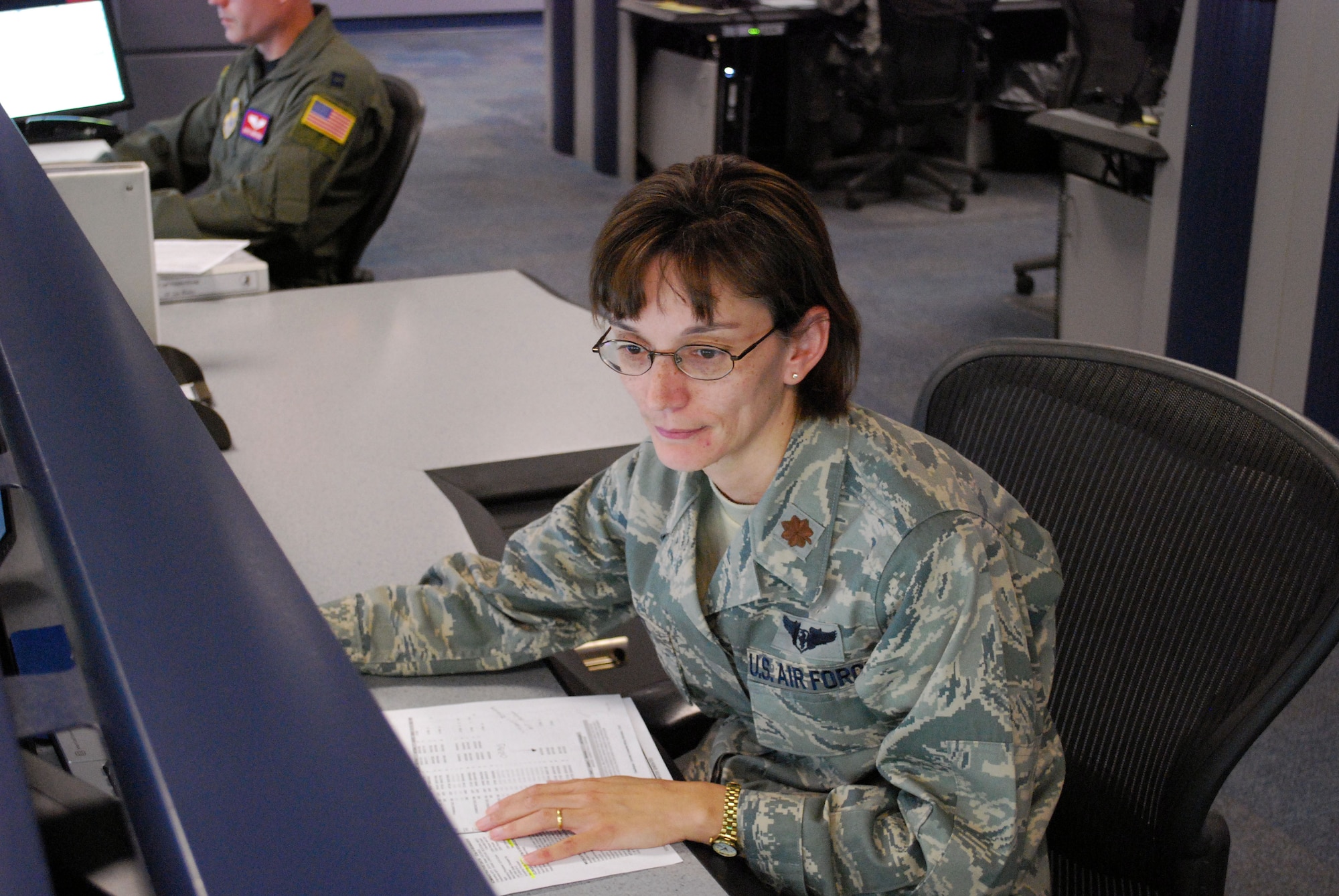 Major Suzie Dietz, Chief of Aeromedical Evacuation Operations at the 618th Tanker Airlift Control Center, reviews a list of worldwide aeromedical evacuation requirements at Scott Air Force Base, Ill., Sept. 3.  The 618th TACC coordinates multiple AE flights daily to transport injured servicemembers to further medical care around the world.  (U.S. Air Force Photo/Capt. Justin Brockhoff)