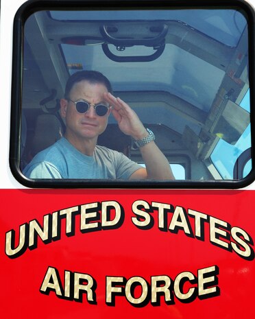 NELLIS AIR FORCE BASE, Nev. -- Mr. Gary Sinise salutes members of the Nellis fire department as he takes a ride in a fire truck, Sept. 7.  Mr. Sinise spent the day visiting Nellis Airmen at various agencies. (U.S. Air Force photo by Staff Sgt. William Coleman)
