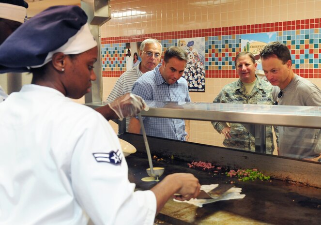 Nellis Air Force Base, Nev. -- Airman 1st Class Tiffany Simmonds, a service apprentice assigned to the 99th Force Support Squadron, prepares an omelet for Gary Sinise at the Crosswinds Dining Facility, Sept. 7. Mr. Sinise visited Nellis Airmen and was accompanied by Col. Steven Winklmann, 99th Air Base Wing vice commander, and Chief Master Sgt. Alfred Herring, 99th Air Base Wing command chief.  
(U.S. Air Force photo by Staff Sgt. William Coleman)