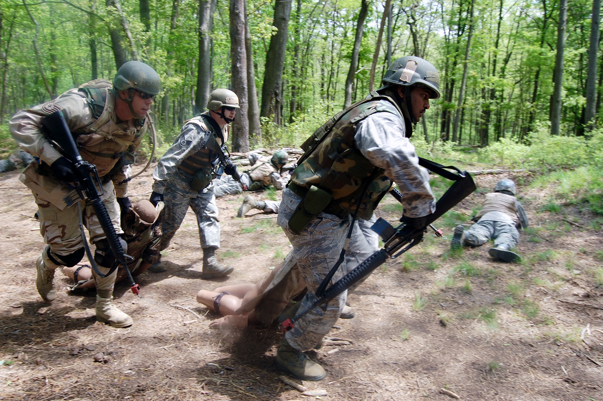 Students in the Advanced Contingency Skills Training Course move simulated victims during training May 11, 2009, at Joint Base McGuire-Dix-Lakehurst, N.J. The training prepares Airmen for upcoming deployments. (U.S. Air Force photo/Tech. Sgt. Scott T. Sturkol) 
