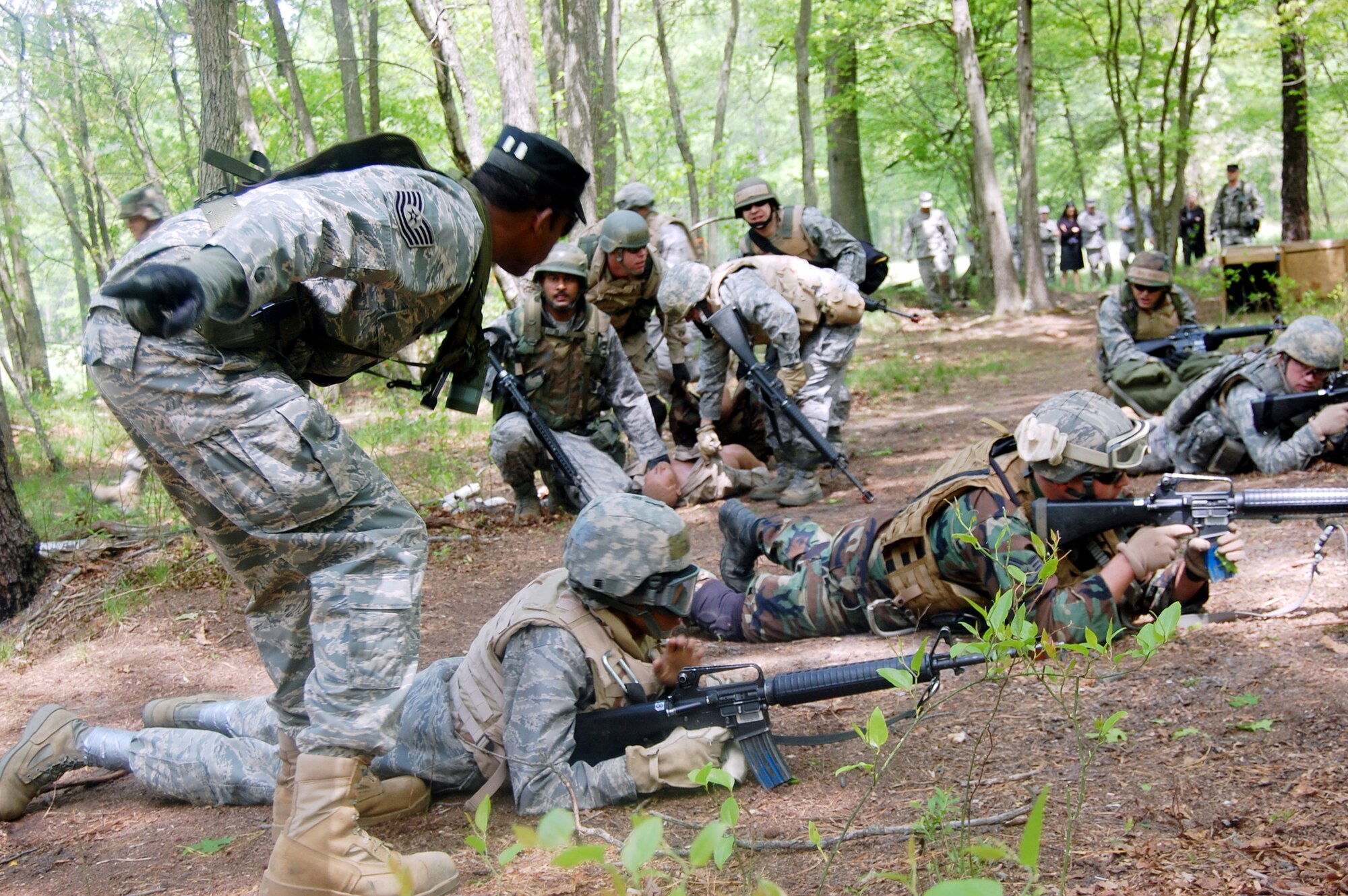 Tech. Sgt. Bernard Wilson provides instruction to students in the Advanced Contingency Skills Training Course as they respond to a scenario requiring response to "enemy fire" during training May 11, 2009, at Joint Base McGuire-Dix-Lakehurst, N.J. Sergeant Wilson is a contingency skills instructor with the Air Force Expeditionary Center's 421st Combat Training Squadron. (U.S. Air Force photo/Tech. Sgt. Scott T. Sturkol) 