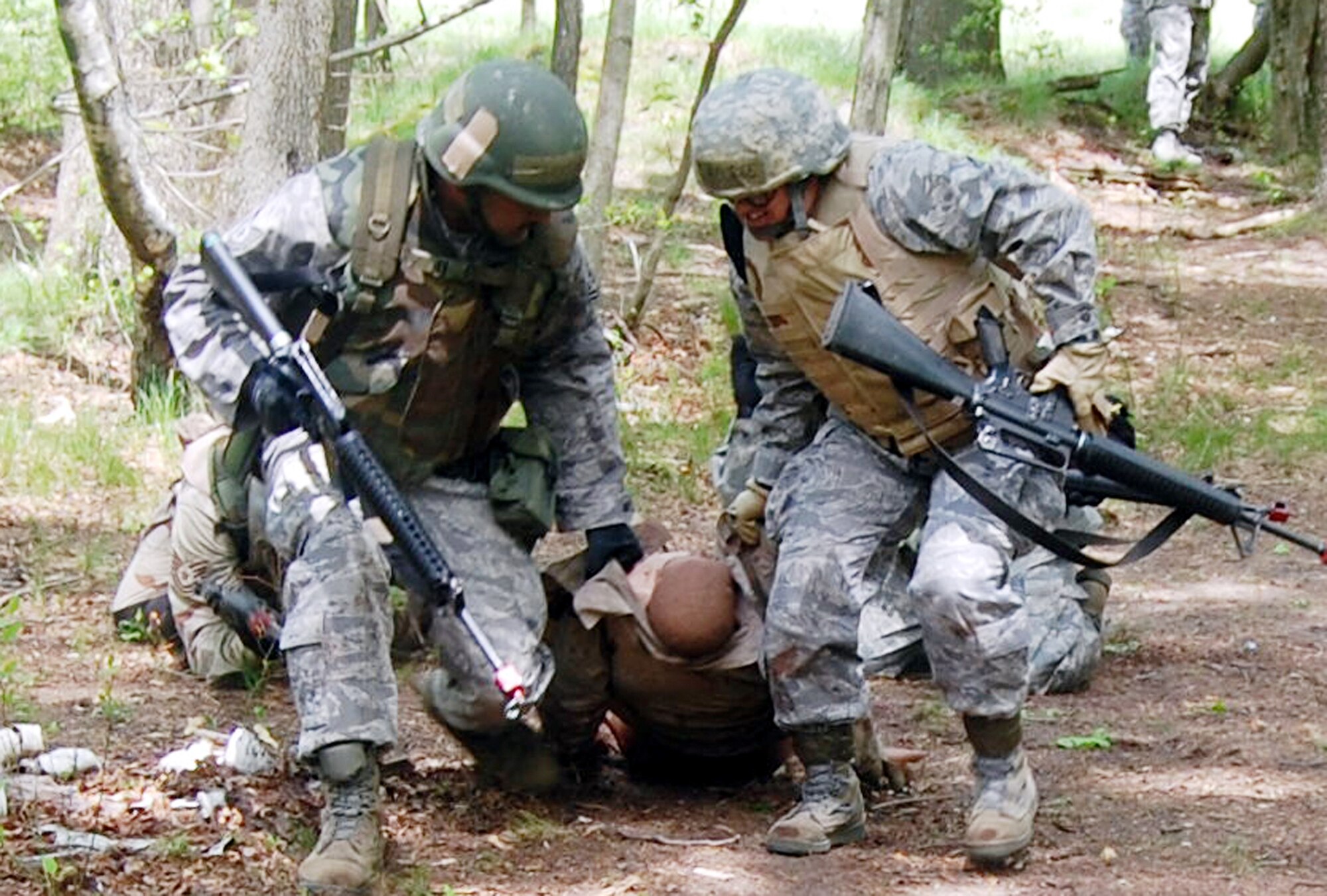 Students in the Advanced Contingency Skills Training Course move simulated victims during training May 11, 2009 at Joint Base McGuire-Dix-Lakehurst, N.J. The training prepares Airmen for upcoming deployments. (U.S. Air Force photo/Tech. Sgt. Scott T. Sturkol) 