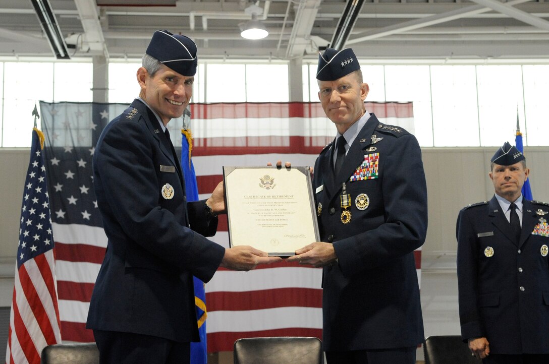 LANGLEY AIR FORCE BASE, Va.-- Gen. John D.W. Corley, Air Combat Command commander receives his retirement certificate from Gen. Norton A. Schwartz, who was at that time the Chief of Staff of the Air Force. The retirement took place during the ACC change of command ceremony here Sept. 10.  General Corley assumed command of ACC in October 2007.  He retired from the U.S. Air Force after 36 years of service.  (U.S. Air Force photo/Senior Airman Dana Hill)