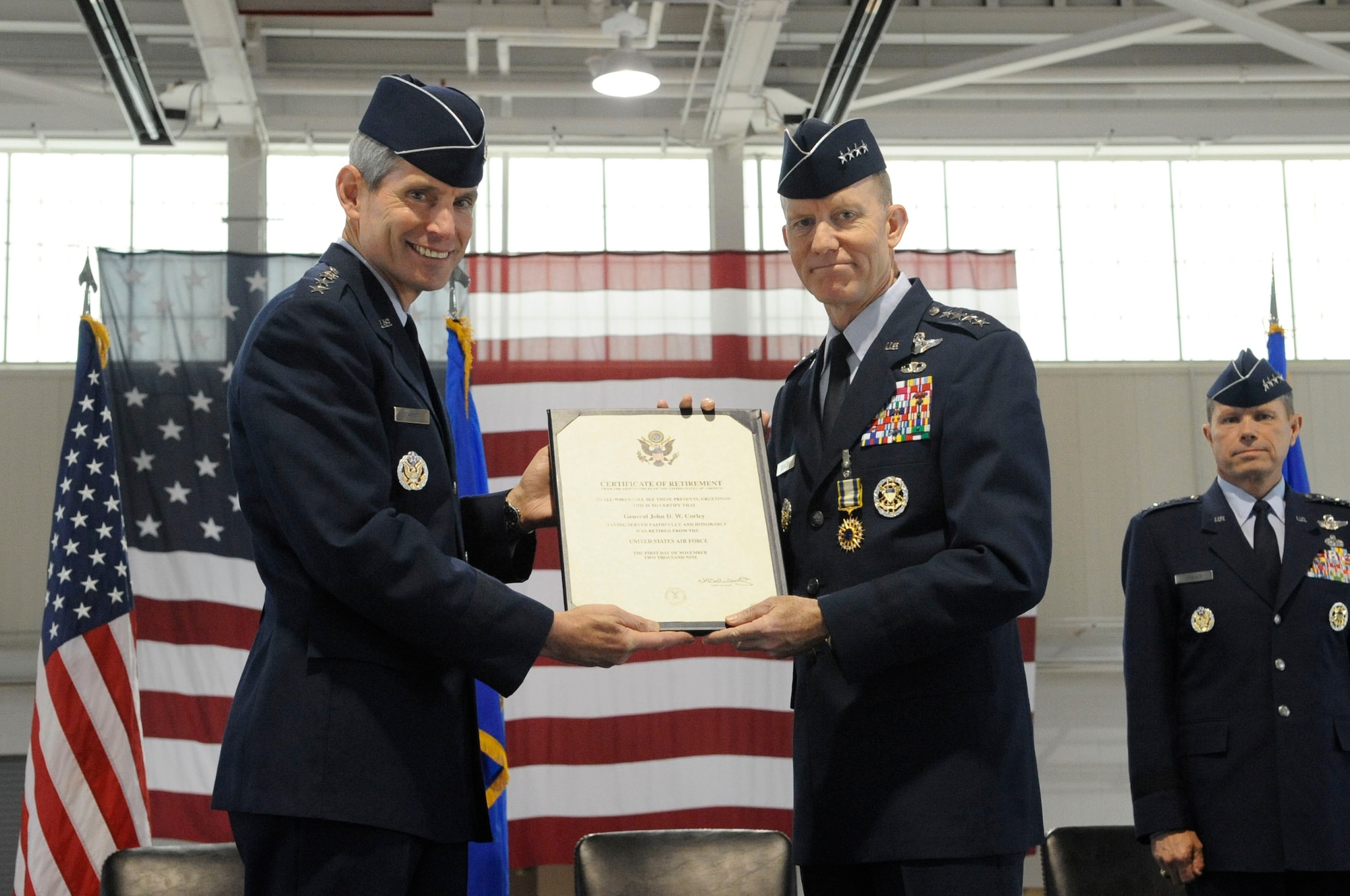 LANGLEY AIR FORCE BASE, Va.-- Gen. John D.W. Corley, Air Combat Command commander receives his retirement certificate from Gen. Norton A. Schwartz, who was at that time the Chief of Staff of the Air Force. The retirement took place during the ACC change of command ceremony here Sept. 10.  General Corley assumed command of ACC in October 2007.  He retired from the U.S. Air Force after 36 years of service.  (U.S. Air Force photo/Senior Airman Dana Hill)