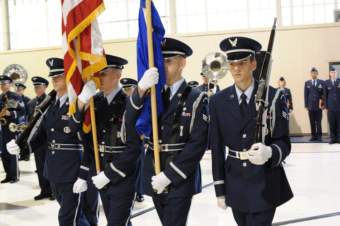 LANGLEY AIR FORCE BASE, Va. – Langley Honor Guard members, Senior Airman Eric Holland, 10th Intelligence Squadron systems program manager, Senior Airman Adam Underwood, 27th IS war operations center controller, Senior Airman Joshua Chevalier, 1st Equipment Maintenance Squadron aircraft armament systems journeyman, and Senior Airman Howard Philip, 82nd Communications Support Squadron systems administrator, present the Colors during the Air Combat Command change-of-command ceremony in the 71st Fighter Squadron hangar Sept. 10. Gen. John D.W. Corley relinquished command to Gen. William M. Fraser III after commanding ACC since October 2007 and serving his country for more than 36 years.  (U.S. Air Force photo/Staff Sgt. Barry Loo)