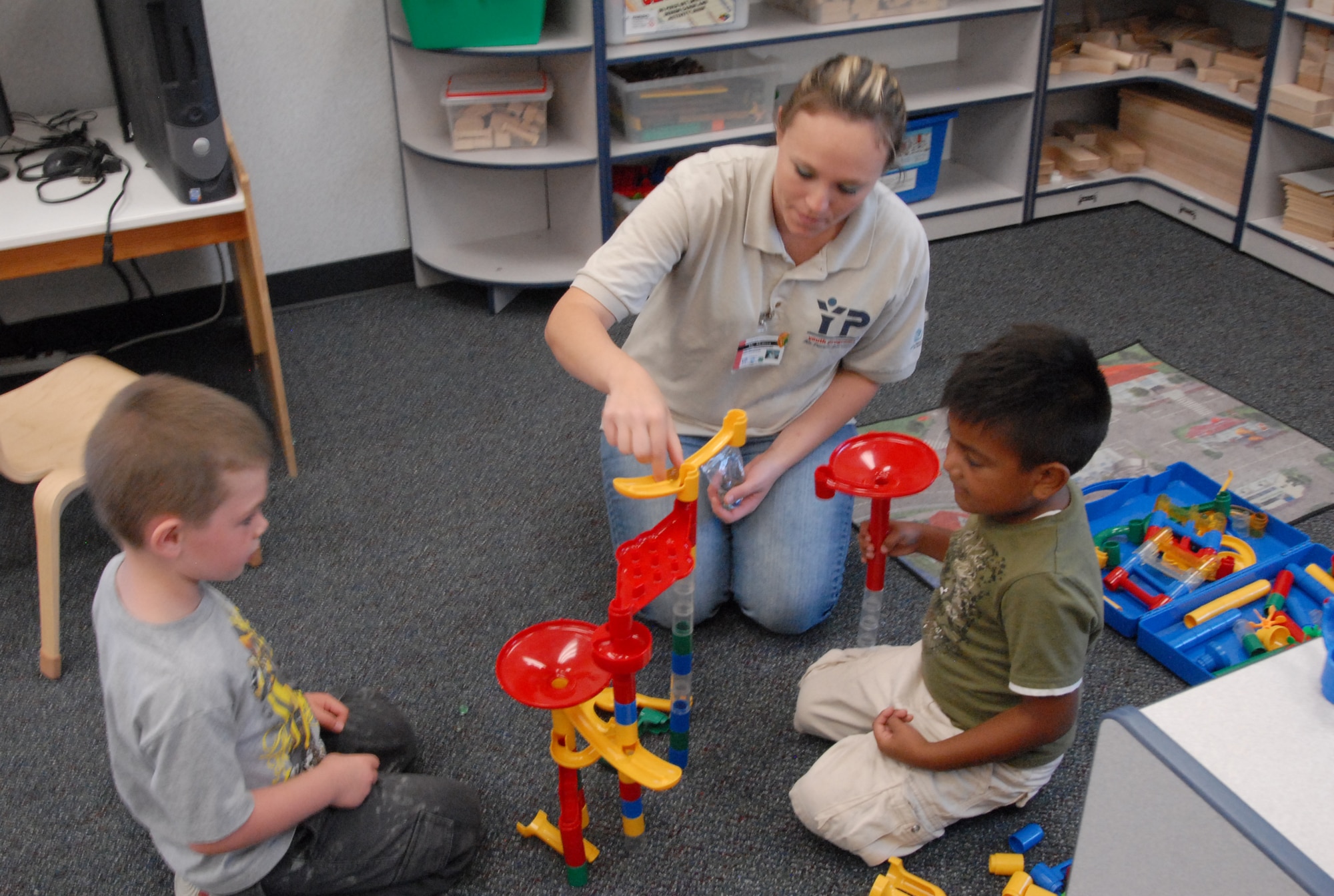 A teacher works with children in one of the two new classrooms added to the Youth Center Annex Sept.11. The $1 million construction project added two new classrooms to the annex, as well as new playgrounds for both the Youth Center and Youth Center Annex. (Air Force photo/Airman 1st Class William O'Brien)