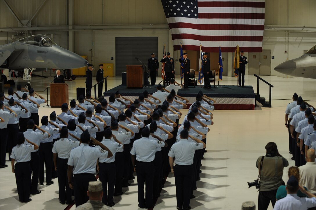 LANGLEY AIR FORCE BASE, Va. - Military members stand and salute for the arrival of the official party during the Air Combat Command change-of-command ceremony Sept. 10 in the 71st Fighter Squadron hangar. Gen. John D.W. Corley relinquished command to Gen. William M. Fraser III after commanding ACC since October 2007. (U.S. Air Force photo/Airman 1st Class Jonathan Koob)