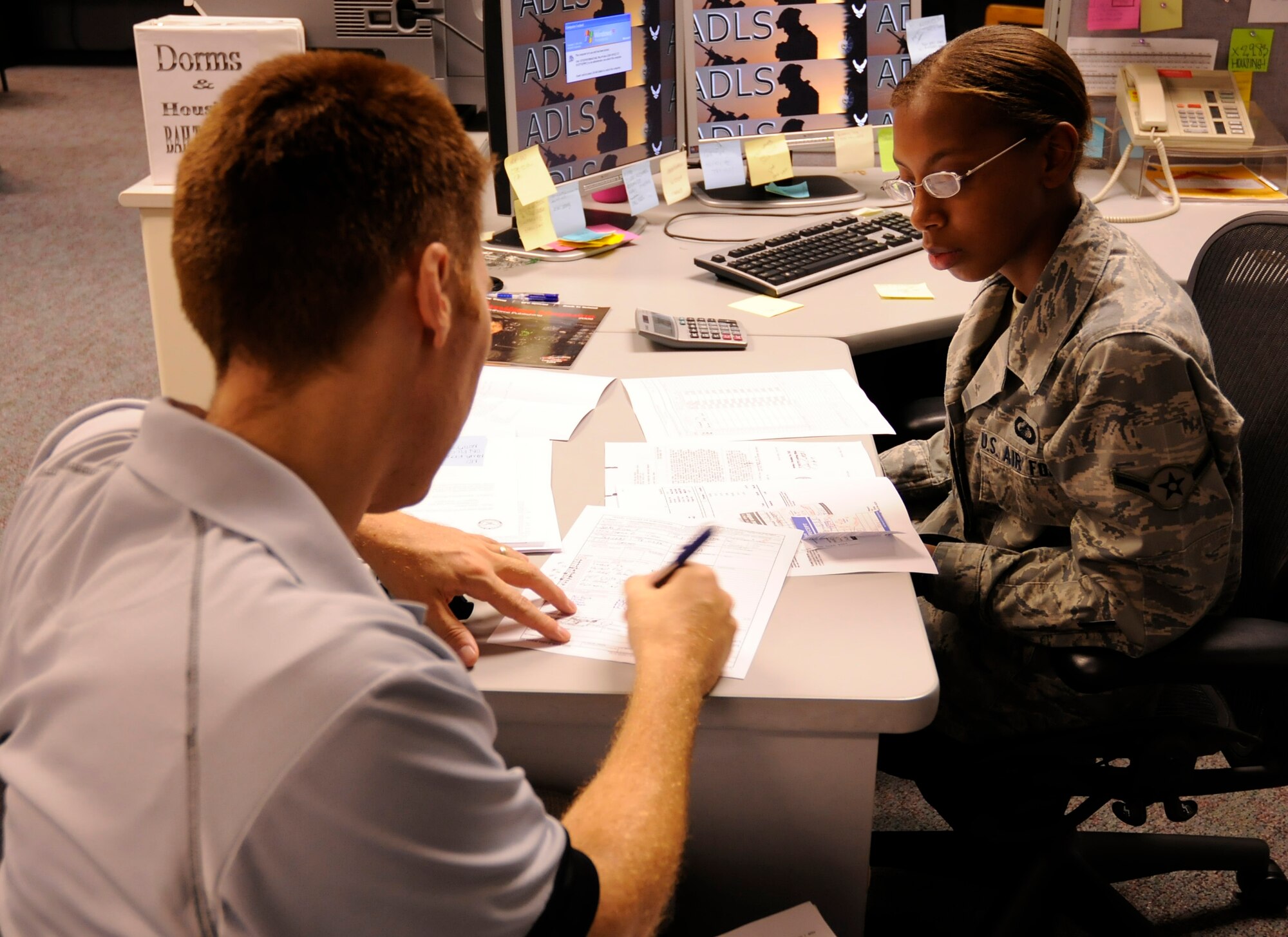 CANNON AIR FORCE BASE, N.M. -- Capt. Eric Spotts, 3rd Special Operations Squadron, receives instructions on how to fill out his post-deployment travel voucher from Airman Jasmine Lear, 27th Special Operations Comptroller Squadron. 27 SOCPTS is responsible for handling all temporary duty assignment travel vouchers, along with civilian and military pay. The finance office is open from 8:30 a.m. to 3:00 p.m. for further questions and concerns. (U.S. Air Force photo/ Senior Airman Erik Cardenas)                                                                                                                                                                                                                                                                                                                                                                                                                                                                                                                                                                                                                                                                                                                                                                                                                                                                                                                                                                                                                                                                                                                                                                                                                                                                                                                                                                                                                                                                   