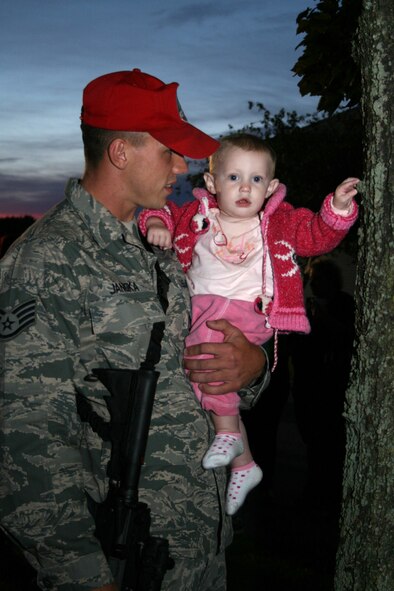 Staff Sgt. Michael Janoka of the 201st RED HORSE squadron holds his niece Zoey while saying goodbye to his family members before his six-month deployment.  