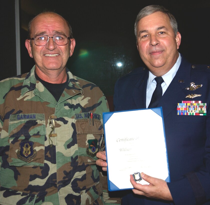 GRISSOM AIR RESERVE BASE, Ind., -- Master William Garman, a KC-135R crew chief, receives a  pin and certificate celebrating his 30 years of service, by  Brig. Gen. Dean Despinoy, 434th Air Refueling Wing commander, right.  The presentation was made during a civilian commander's call held recently. (U.S. Air Force photo/Tech. Sgt. Doug Hays)