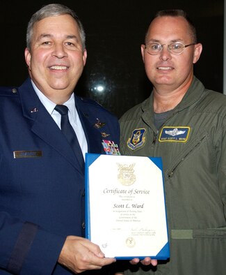 GRISSOM AIR RESERVE BASE, Ind., -- Master Sgt. Scott Ward, a boom operator with the 72nd Air Refueling Squadron, receives a 20-year pin and certificate Brig. Gen. Dean Despinoy, 434th Air Refueling Wing commander, right.  The presentation was made during a civilian commander's call held recently. (U.S. Air Force photo/Tech. Sgt. Doug Hays)
