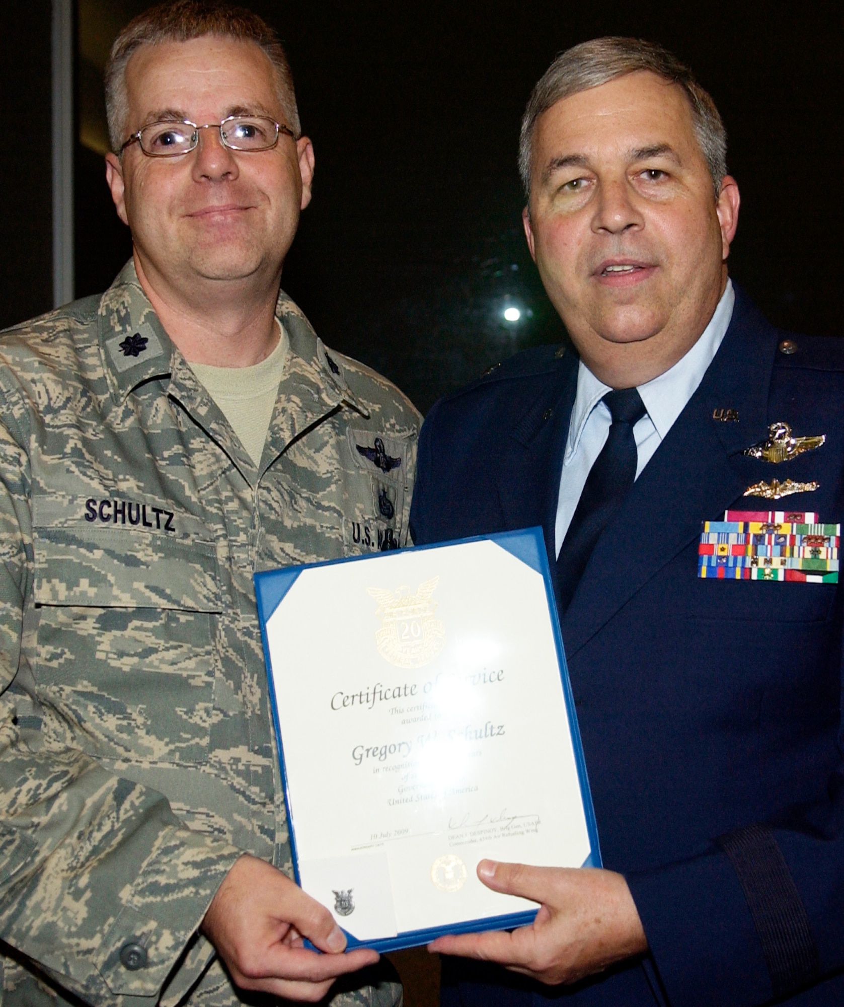 GRISSOM AIR RESERVE BASE, Ind., -- Lt. Col. Greg Schultz, senior intelligence officer, receives a pin and certificate Brig. Gen. Dean Despinoy, 434th Air Refueling Wing commander, right.  Colonel Schultz has more than 20 years of civil service. The presentation was made during a civilian commander's call held recently. (U.S. Air Force photo/Tech. Sgt. Doug Hays)