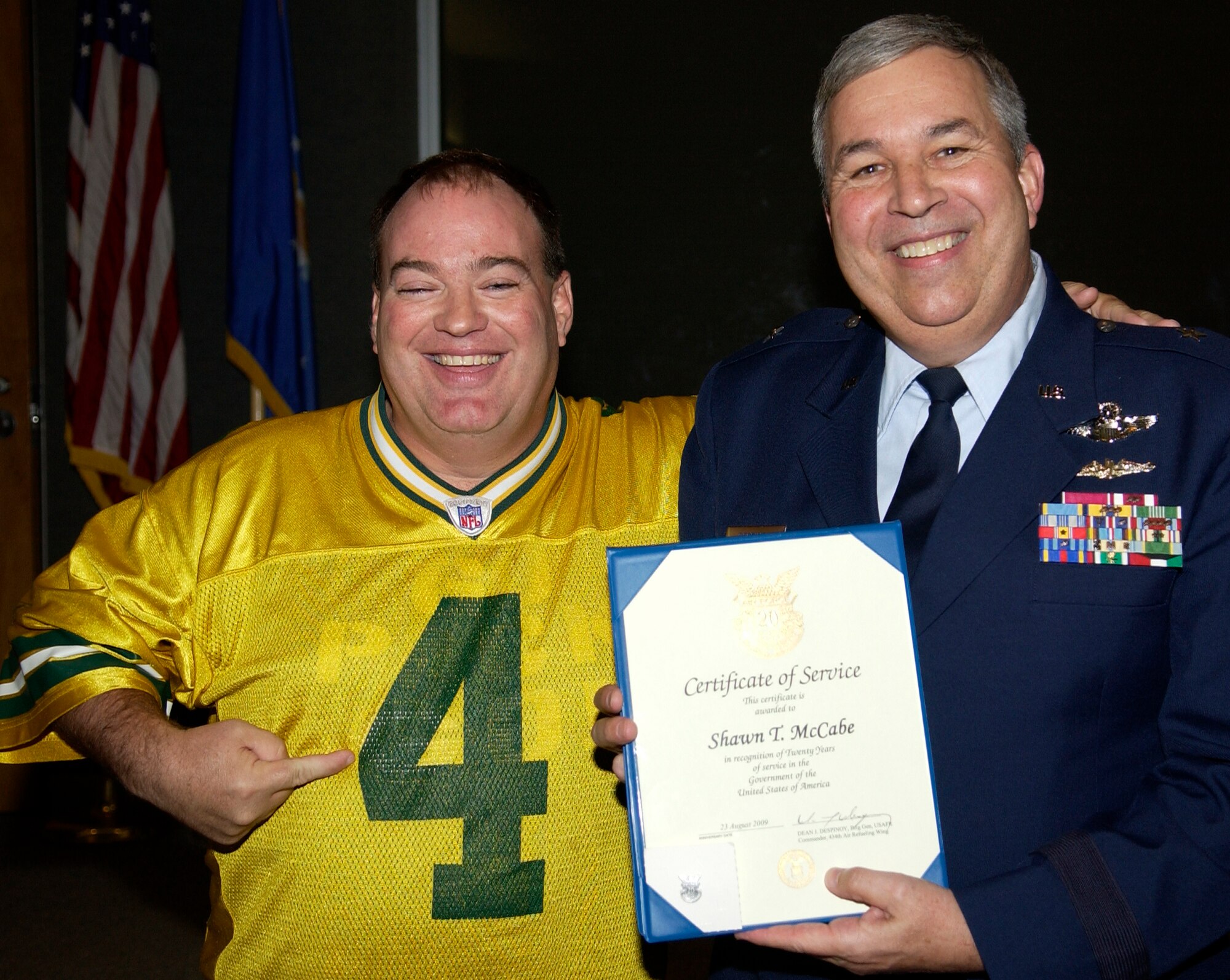 GRISSOM AIR RESERVE BASE, Ind., Shawn McCabe, a logistics plans technician, jokes around as he is presented a certificate and pin marking his 20 years of service from Brig. Gen. Dean Despinoy, 434th Air Refueling Wing commander, right.  The presentation was made during a civilian commander's call held recently. (U.S. Air Force photo/Tech. Sgt. Doug Hays)
