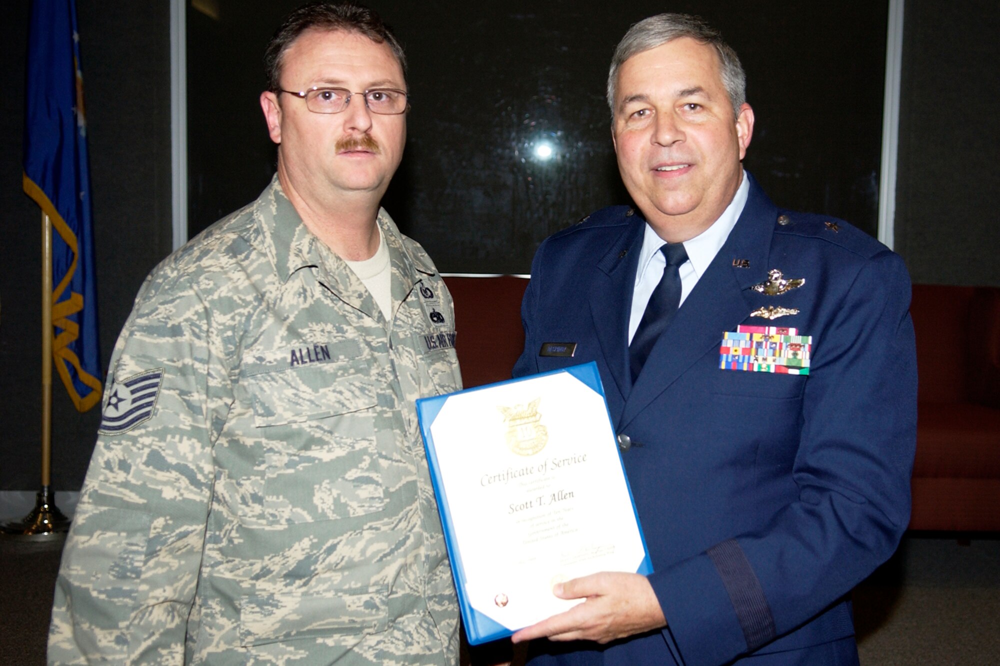 GRISSOM AIR RESERVE BASE, Ind., -- Tech. Sgt. Scott Allen, an aircrew survival equipment repairman with the 434th Operations Support Squadron, is recognized by Brig. Gen. Dean Despinoy, 434th Air Refueling Wing commander, right, for 10 years of civil service. The presentation was made during a commander's call held recently. (U.S. Air Force photo/Tech. Sgt. Doug Hays)