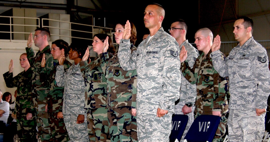 GRISSOM AIR RESERVE BASE, Ind. -- Newly minted staff sergeants raise their hands in preparation to repeating the noncommissioned officer charge given by Chief Master Sgt. Larry Brady, 434th Air Refueling Wing command chief, during an NCO induction ceremony held during a unit training assembly. The NCO charge outlines the responsibilities and expectations of new NCOs. (U.S. Air Force photo/Staff Sgt. Mark R. W. Orders-Woempner)
