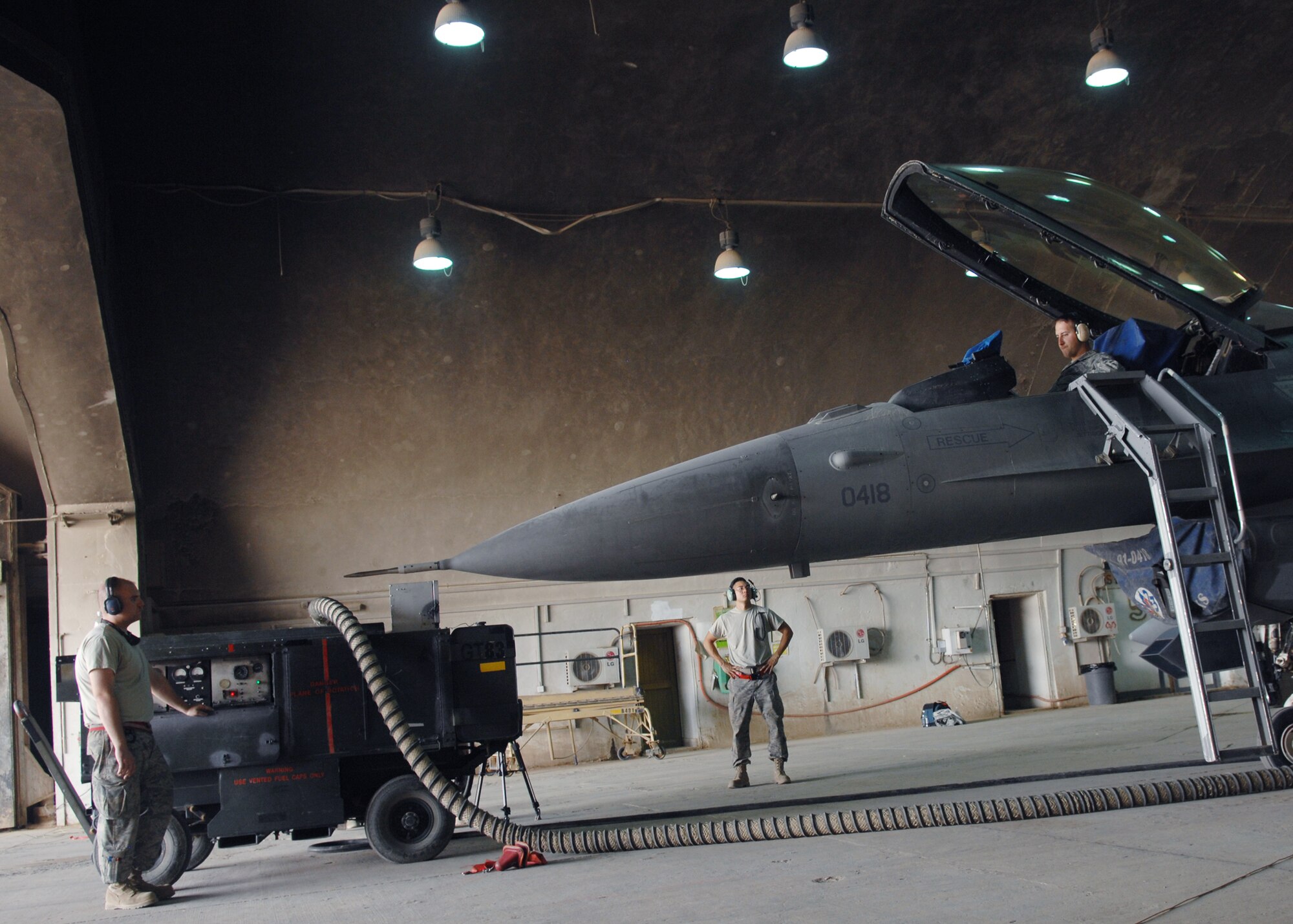 JOINT BASE BALAD, Iraq -- Airmen of the 22nd Expeditionary Aircraft Maintenance Unit use a generator to power up a sniper pod at the flightline here Sep. 3. The sniper pod provides video imagery to ground forces to identify areas of interest during military operations. The 22nd AMU is deployed from Spangdahlem Air Base, Germany.  (U.S. Air Force photo/Senior Airman Christopher Hubenthal)