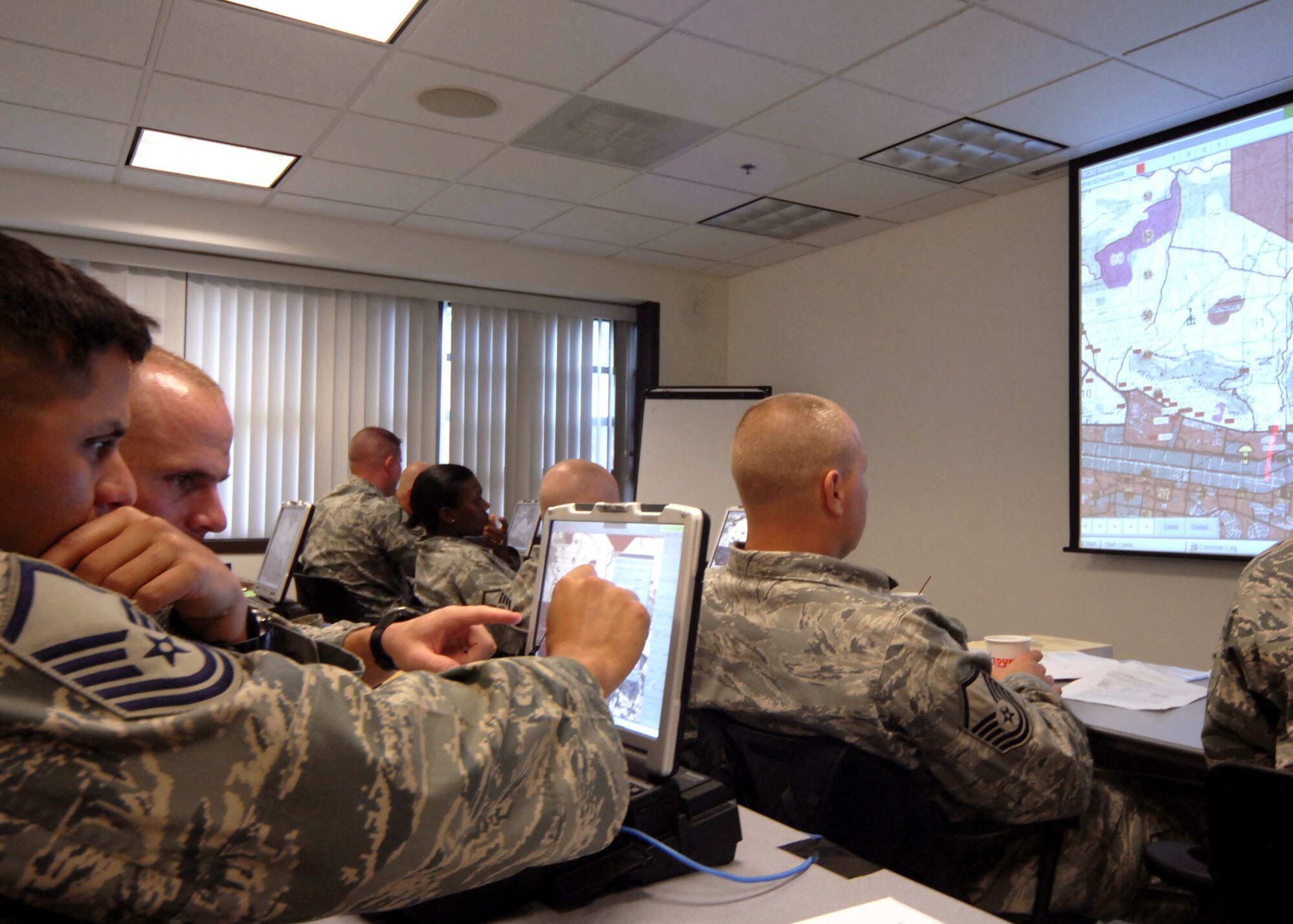 Security forces Airmen train on the Army's Blue Force Tracker system during their pre-deployment training at the Air Force Expeditionary Center's 421st Combat Training Squadron Aug. 29, 2009, at Joint Base McGuire-Dix-Lakehurst, N.J. The Blue Force Tracker is a system that gives air and ground units and their commanders a real-time picture of the battlefield. (U.S. Air Force photo/Tech. Sgt. Paul R. Evans) 
