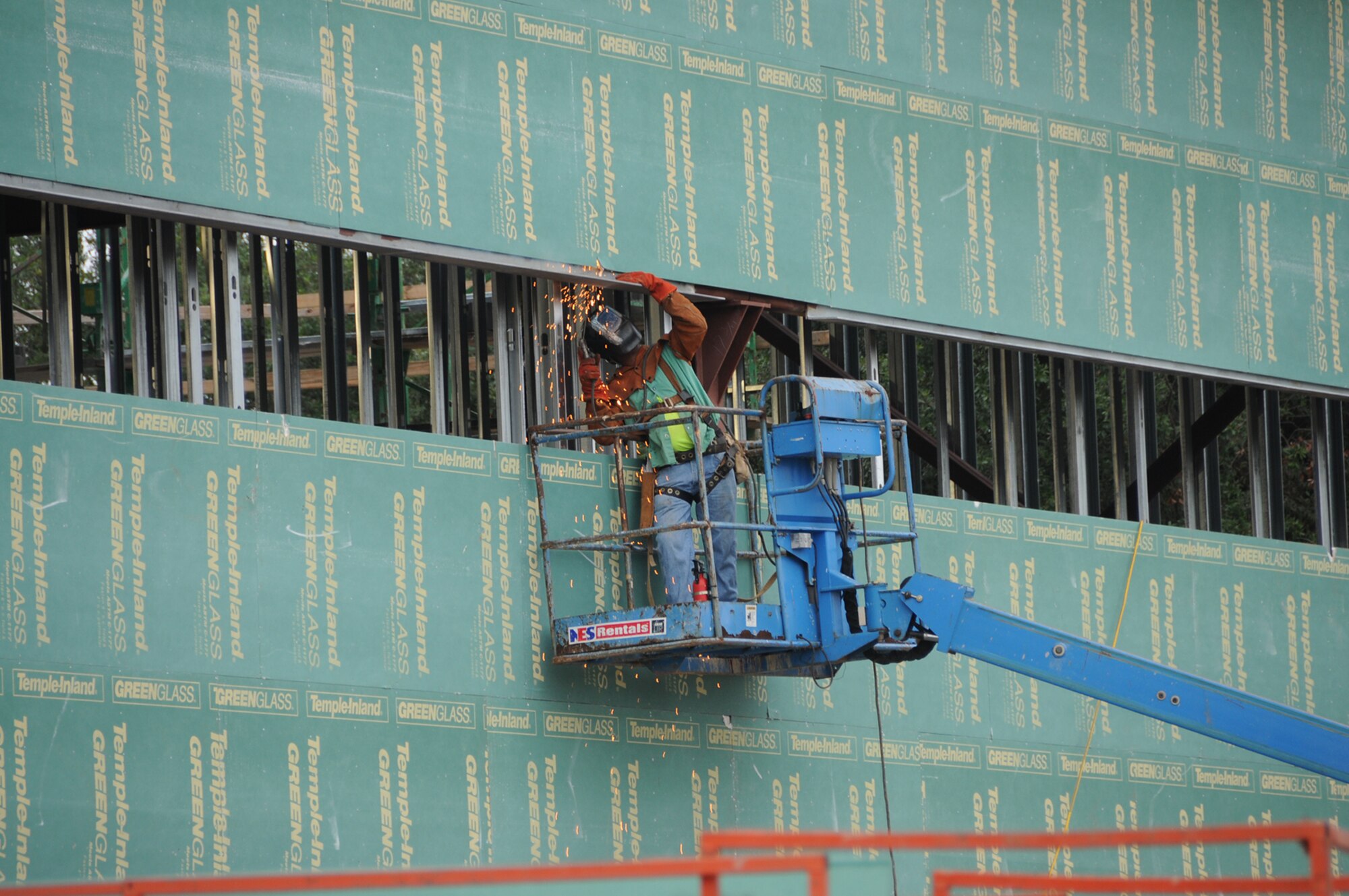 Isaac Stubbs, Bracken Construction, welds a brick relief angle on the training aids building.  (U.S. Air Force photo by Kemberly Groue)