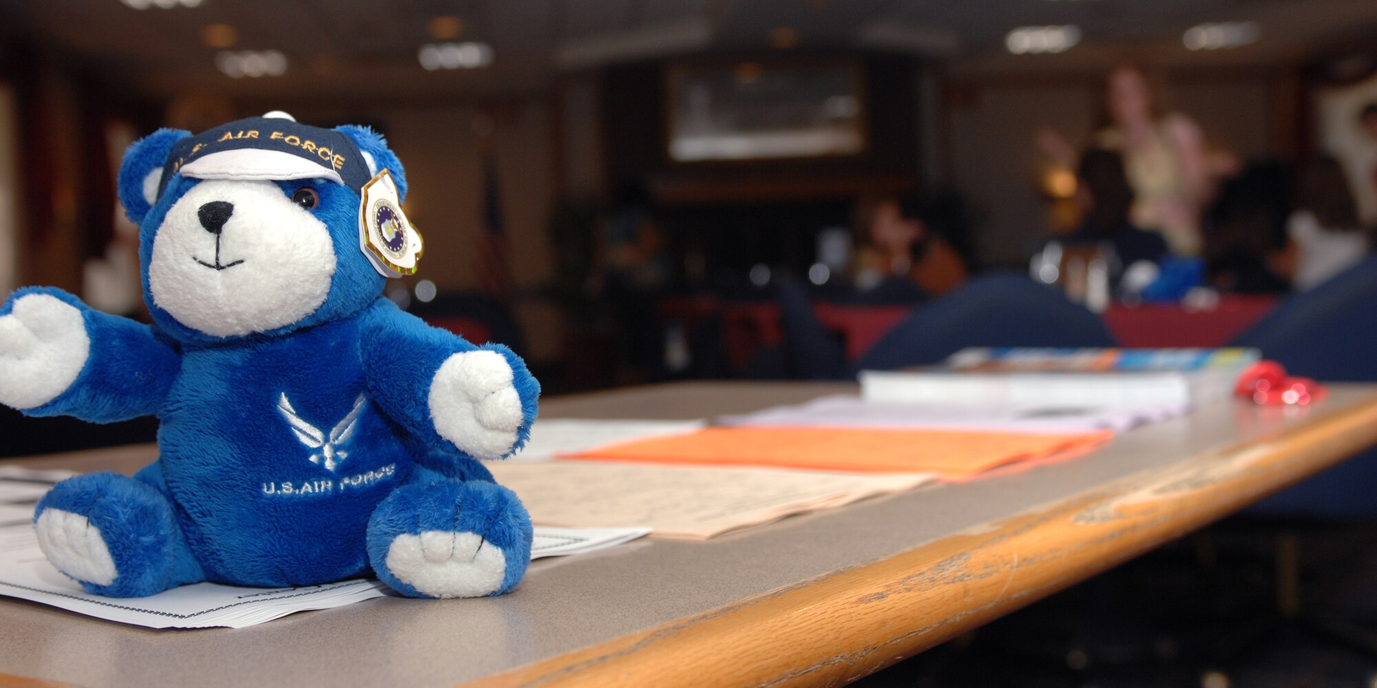 CANNON AIR FORCE BASE, N.M. -- A teddy bear sits upon the sign-in table at the dining facility during a deployed spouse's dinner September 8. Master Sgt. Tory Gard, 27th Special Operations Force Support Squadron, is the primary point of contact for the event and can be reached at 784-4456. The Airman and Family Readiness center runs the dinners quarterly and the next dinner will have a Christmas theme and will be held December 8. The dinners are meant to give parents and spouses a time to get together and not have to cook or clean for a night and have dinner prepared for them with gifts given to them funded by private organizations around the base.  (U.S. Air Force photo by Airman 1st Class James Bell) 