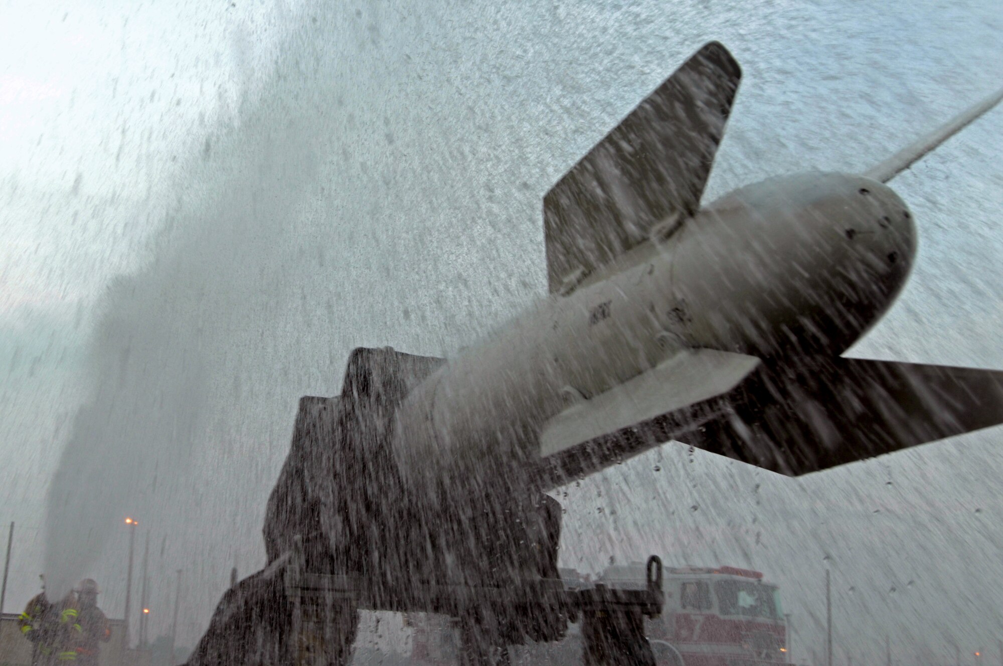 WHITEMAN AIR FORCE BASE, Mo. - A B-16 missile is doused in water by Airman 1st Class Timothy Vanden Haak and Tech. Sgt. Ben Hosbein, 509th Civil Engineer Squadron firefighters, during a Mass Accident Response Exercise, Sept. 9. Airmen participating in the exercise were faced with a weapons transport that had come under enemy fire, resulting in injured casualties, a contamination spill and an ignited B-61 missile.  Firefighters, security forces, medical, explosive ordinance and munitions personnel all played major roles in the exercise to successfully complete all tasks and meet training requirements. (U.S. Air Force photo/Senior Airman Kenny Holston) 