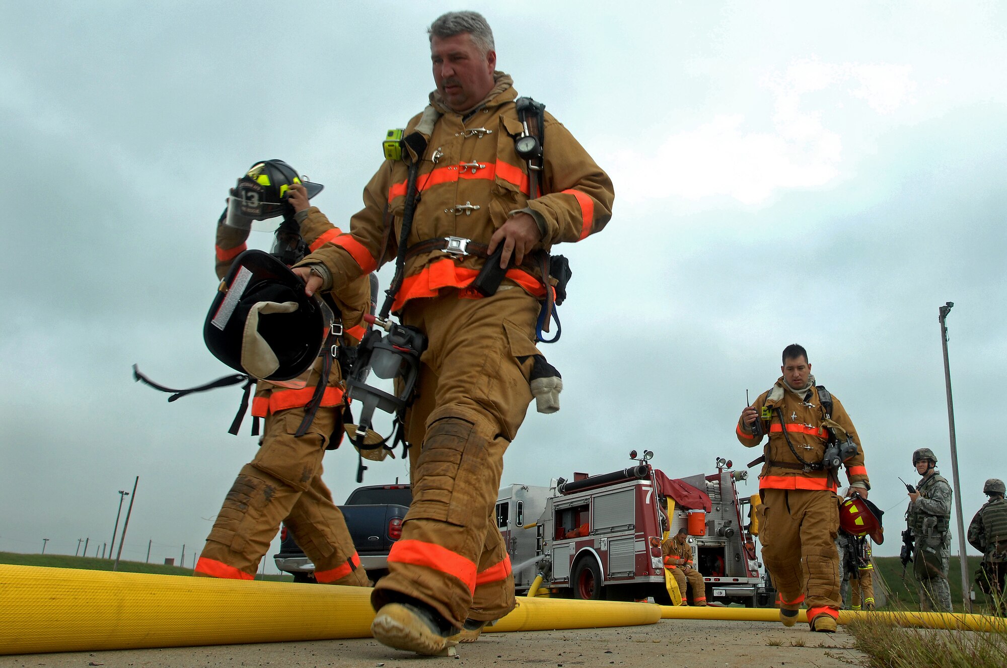 WHITEMAN AIR FORCE BASE, Mo. - Gregory Smith, 509th Civil Engineer Squadron firefighter, leads his crew across the exercise grounds during a Mass Accident Response Exercise, Sept. 9. Airmen participating in the exercise were faced with a weapons transport that had come under enemy fire, resulting in injured casualties, a contamination spill and an ignited B-61 missile.  Firefighters, security forces, medical, explosive ordinance and munitions personnel all played major roles in the exercise to successfully complete all tasks and meet training requirements. (U.S. Air Force photo/Senior Airman Kenny Holston)