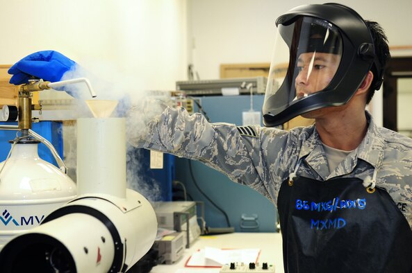 U.S. Air Force Staff Sgt. Jirayu Wisutapayak, a precision measurement equipment laboratory technician, with the 86th Maintenance Squadron, fills a portion of equipment with liquid nitrogen as part of the start-up process of testing the accuracy of heat seeking missiles.  Wisutapayak, originally from just south of Bangkok Thailand, is only one of two active duty Airmen who are certified to use the Graseby IR Systems MK-III Radiometer.  (U.S. Air Force photo by Staff Sgt. Jocelyn Rich) 