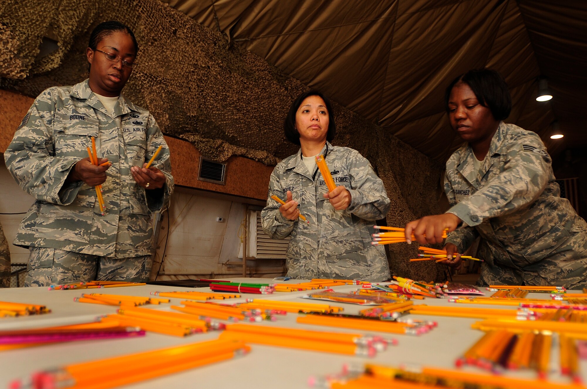 ALI BASE, Iraq - Airmen from the 407th Air Expeditionary Group assembled Sept. 5, 2009 in order to package school supplies and toys for Operation Iraqi Child.  The school supplies will be distributed to local communities in southern Iraq to prepare children for the upcoming school year. (Photo by / Airman 1st Class Tony R. Ritter)