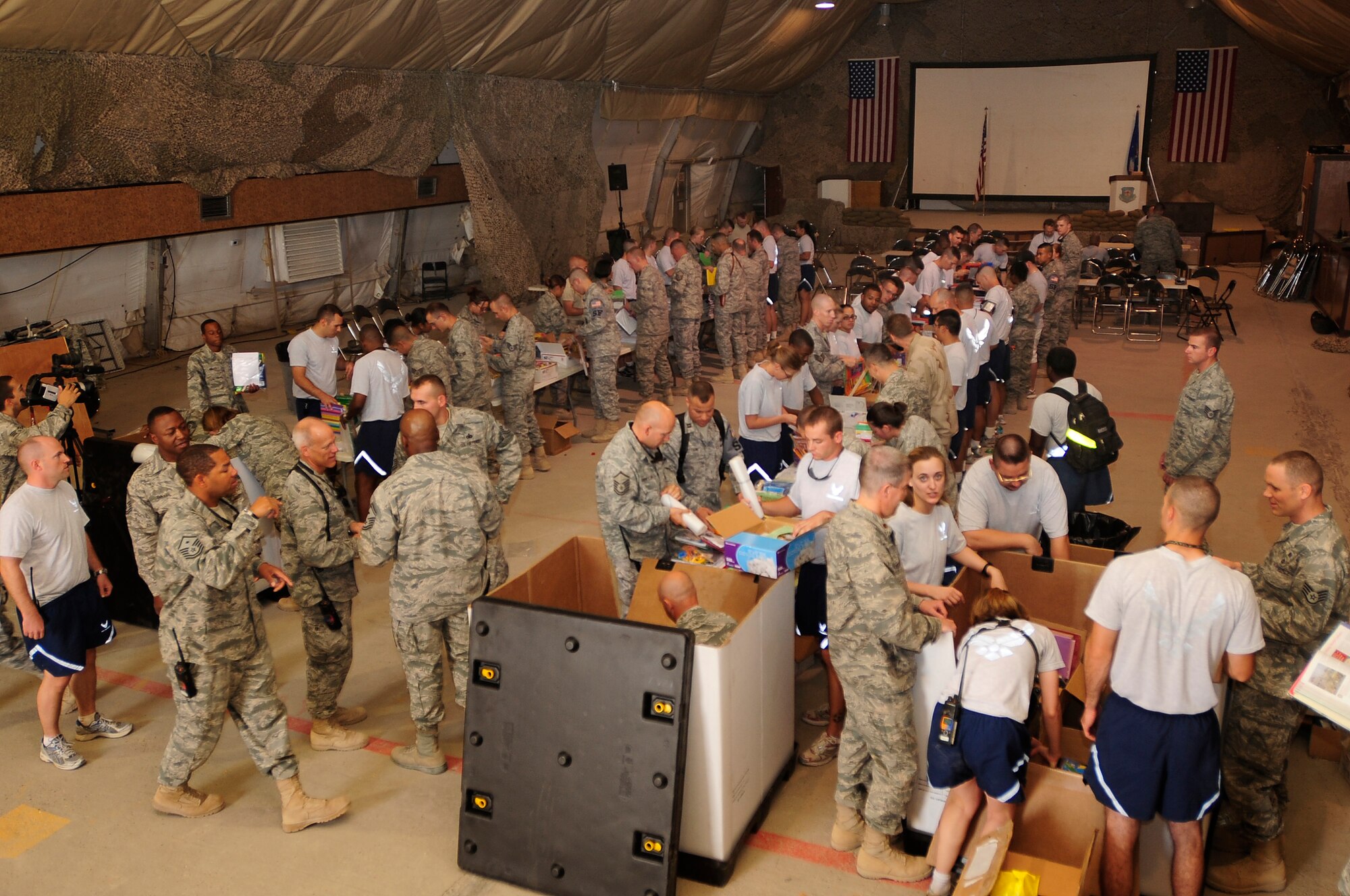 ALI BASE, Iraq - Airmen from the 407th Air Expeditionary Group form an assembly line to package school supplies and toys for Operation Iraqi Child Sept. 5, 2009.  The school supplies will be distributed to local communities in southern Iraq to prepare children for the upcoming school year. (Photo by / Airman 1st Class Tony R. Ritter)