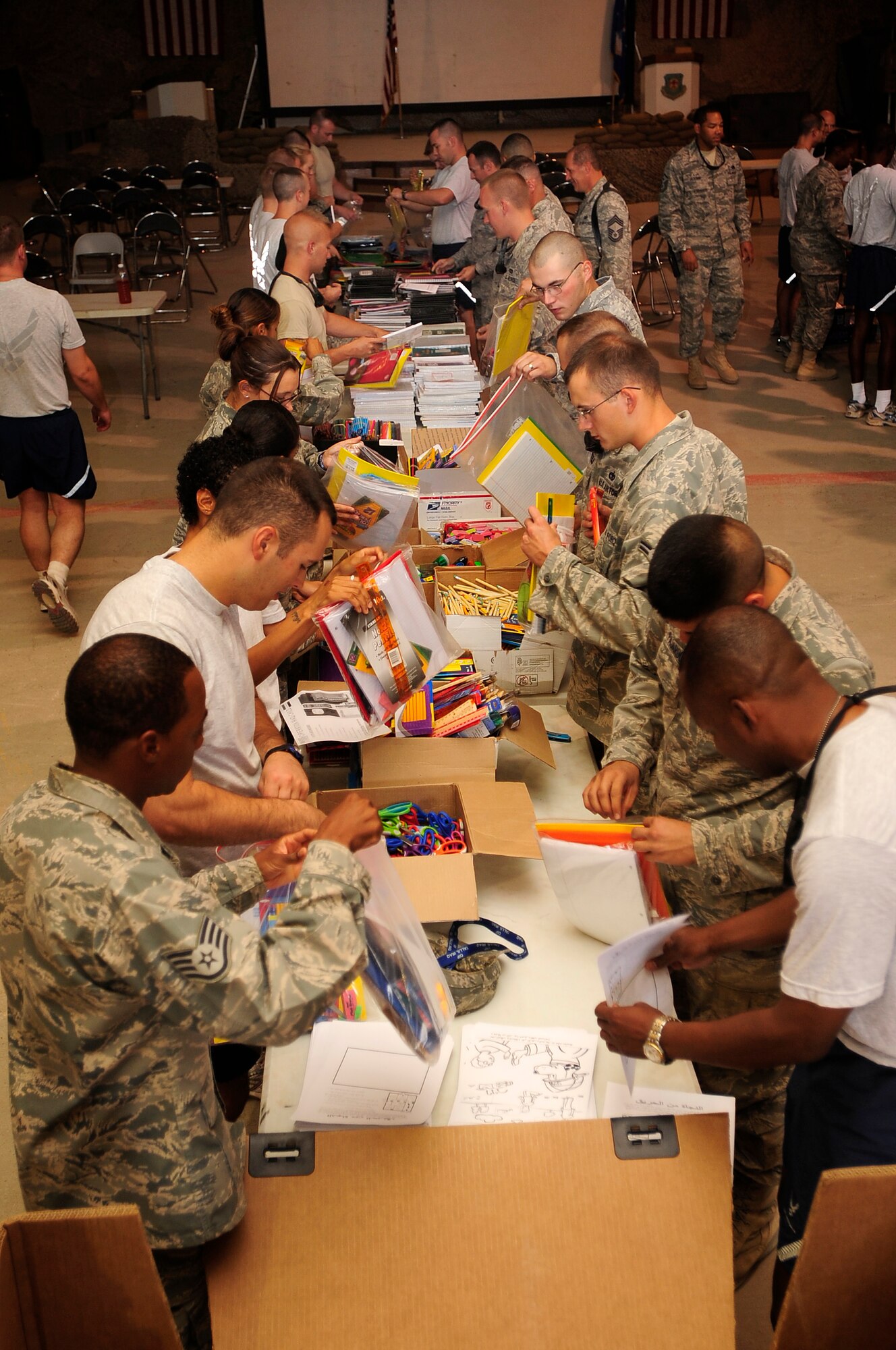 ALI BASE, Iraq - Airmen from the 407th Air Expeditionary Group form an assembly line to package school supplies and toys for Operation Iraqi Child Sept. 5, 2009.  The school supplies will be distributed to local communities in southern Iraq to prepare children for the upcoming school year. (U.S. Air Force photo/Senior Airman Tony R. Ritter)