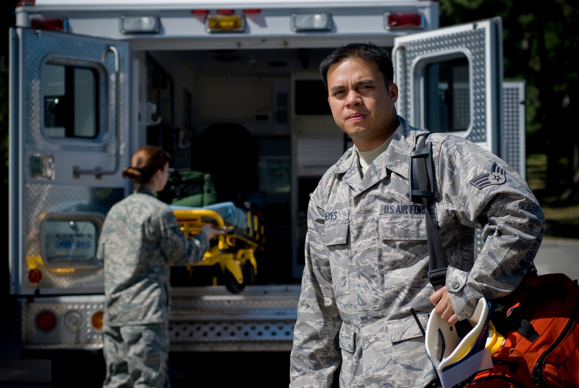 KUNSAN AIR BASE, Republic of Korea --Tech. Sgt. Samantha Mosher and Senior Airman John Reyes, 8th Medical Operations Squadron, stand in for an environmental portrait on Sept. 10. Sergeant Mosher and Airman Reyes are emergency medical technician qualified aerospace medical technicians assigned to ambulance services. Ambulance services primary duties are to respond to 911 calls, in-flight emergencies and sick call. (U.S. Air Force photo / Senior Airman Jonathan Steffen) 