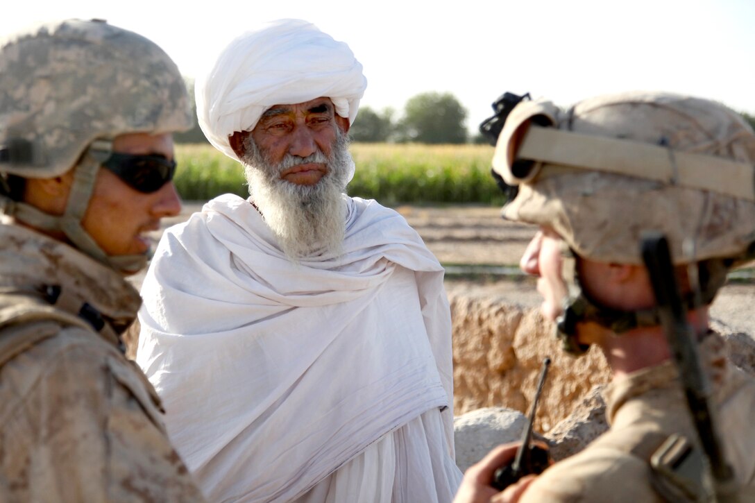 An Afghan elder speaks with U.S. Marine Corps 1st Lt. Zachary Bennett, right, during a road reconnaissance patrol in Helmand province's Nawa district, Afghanistan, Sept. 6, 2009. Bennett is assigned to the 1st Battalion, 5th Marine Regiment.