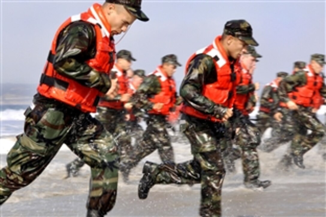 U.S. Navy students in the  Basic Underwater Demolition/SEAL class participate in a surf passage exercise during the first phase of training on Naval Amphibious Base Coronado, Calif., Sept. 10, 2009. Navy SEALs are the maritime component of U.S. Special Forces and are trained to conduct a variety of operations from the sea, air and land.