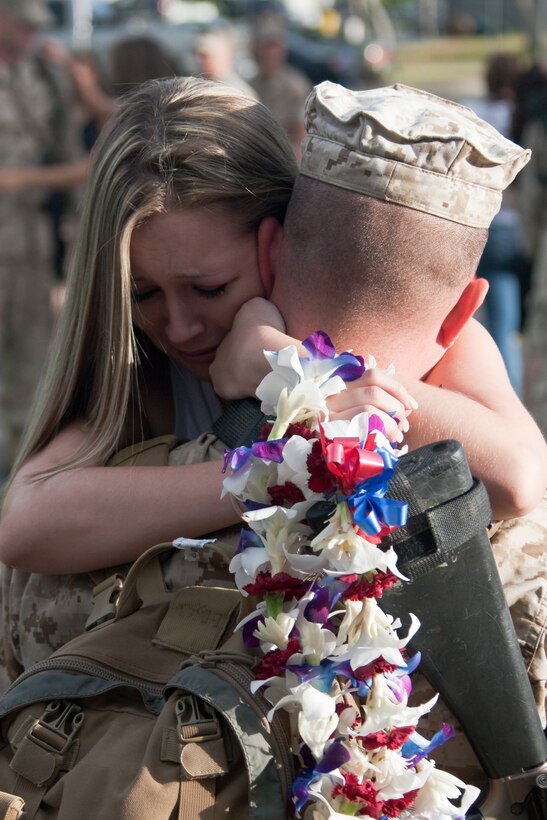 Shannon Allmon embraces her husband for the first in months after his return from Iraq Thursday morning at the base chapel. The Marines and sailors from 3rd Battalion, 3rd Marine Regiment were the first part of the main body to return from the seven-month deployment.