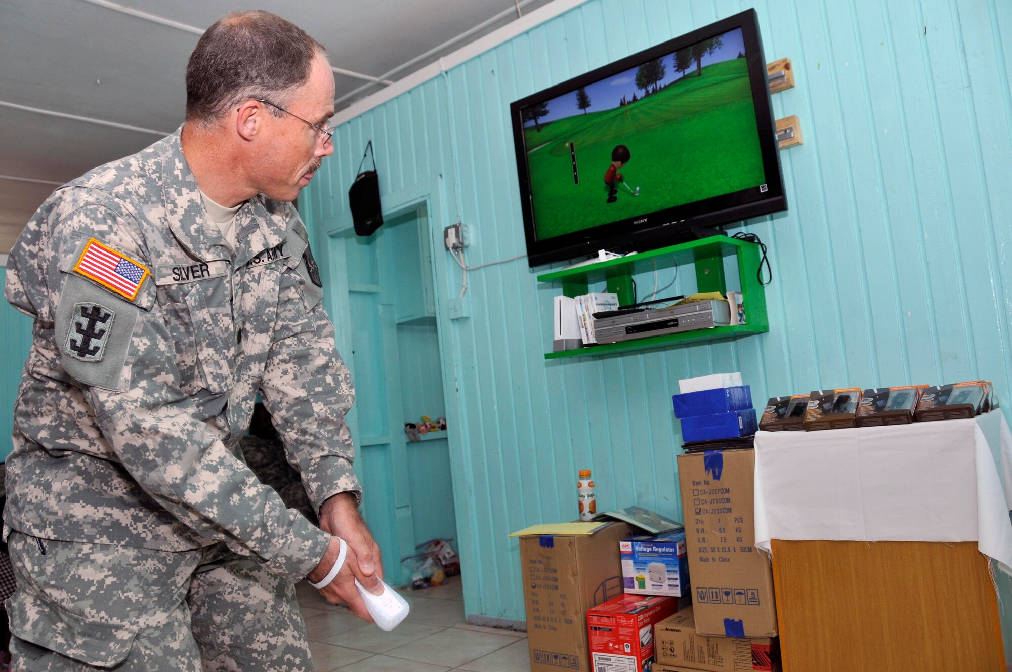 Lt. Col. David Silver commander of the 878th Engineer Battalion, Georgia Army National Guard, tests out the new Nintendo Wii that was donated to the Joshua's Place Orphanage Sept. 9, 2009. Soldiers from the Georgia Army National used donation money collected back home, to buy a 40 inch LCD TV, a Nintendo Wii with six video games, 20 MP3 players and a DVD/VCR player (U.S. Air Force photo by Airman 1st Class Perry Aston) (Released)