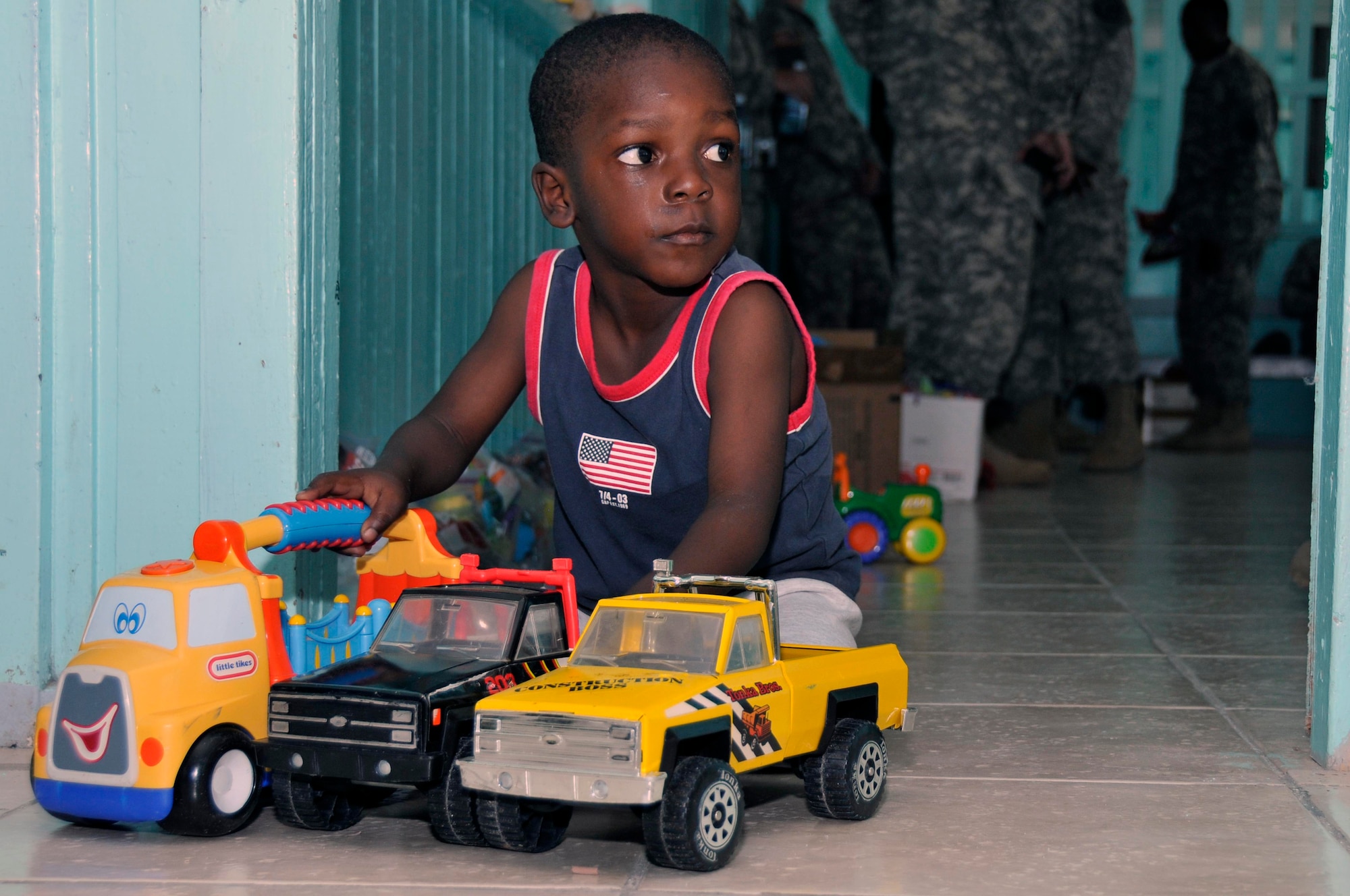 A Guyanese boy from Joshua's Place Orphanage plays with his new toys Sept. 9, 2009. in Georgetown, Guyana. Soldiers from the Georgia Army National Guard brought 32 duffel bags of toys and clothes and over $3,800 in donated items to the orphanage. (U.S. Air Force photo by Airman 1st Class Perry Aston) (Released)