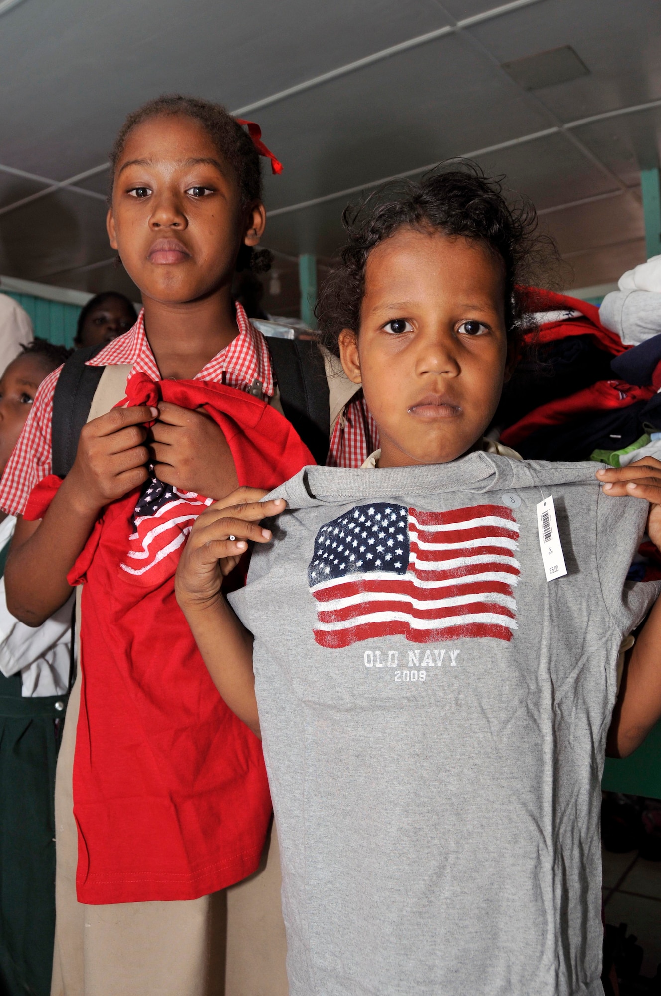 Guyanese girls from Joshua's Place Orphanage show off their new T-shirts Sept. 9, 2009. in Georgetown, Guyana. Soldiers from the Georgia Army National Guard brought 32 duffel bags of toys and clothes and over $3,800 in donated items to the orphanage. (U.S. Air Force photo by Airman 1st Class Perry Aston) (Released)