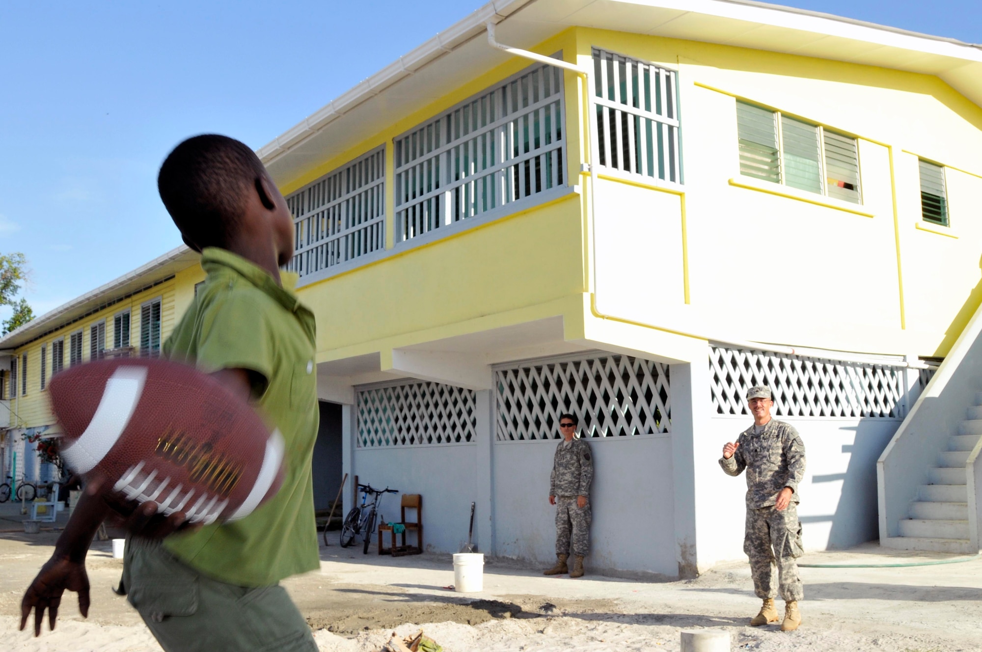 Lt. Col. David Silver commander of the 878th Engineer Battalion, Georgia Army National Guard, plays a game of catch with a boy from Joshua's Place Orphanage Sept. 9, 2009. 878th Engineer Battalion brought 32 duffel bags of toys and clothes and over $3,800 in donated items to the orphanage. (U.S. Air Force photo by Airman 1st Class Perry Aston) (Released)