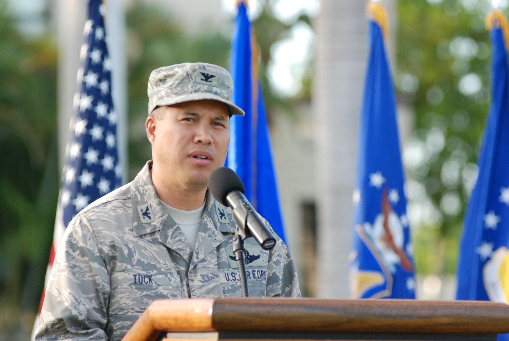 HICKAM AIR FORCE BASE, Hawaii -- Colonel Giovanni Tuck, 15th Airlift Wing commander, speaks during the Sept. 11 Remembrance Ceremony here. Instead of the monthly Warrior Run morale event, Hickam Airman paid tribute to those who lost their lives on 9/11 with a moment of silence in formation during the ceremony. A  15th Airlift Wing C-17 fly-over further honored those on the 8th anniversary. (U.S. Air Force photo/Staff Sgt. Mike Meares)